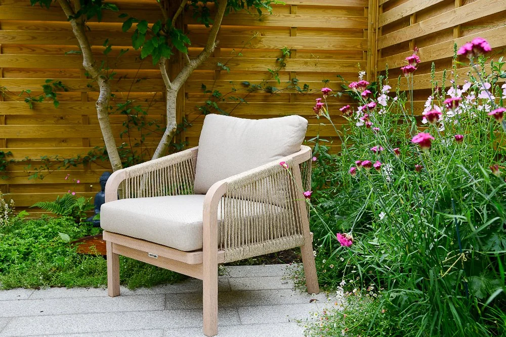 A rope-weave lounge chair beside a border of pink dianthus and sidalcea flowers

A neutral rope-weave lounge chair sits close to a vibrant border of pink dianthus and sidalcea, bringing cottage garden colour right up to the seating area.
