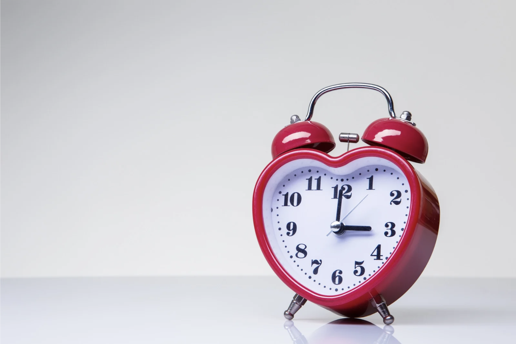 Image of a red alarm clock shaped like a heart