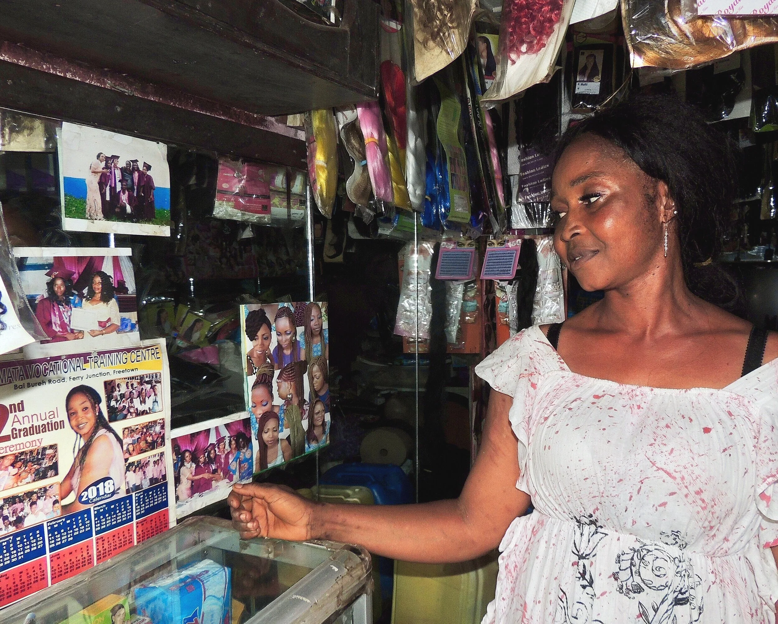 Aunty Effy with a picture of some of the graduated girls from the training program. Photo by Freja Lykke Herrik.