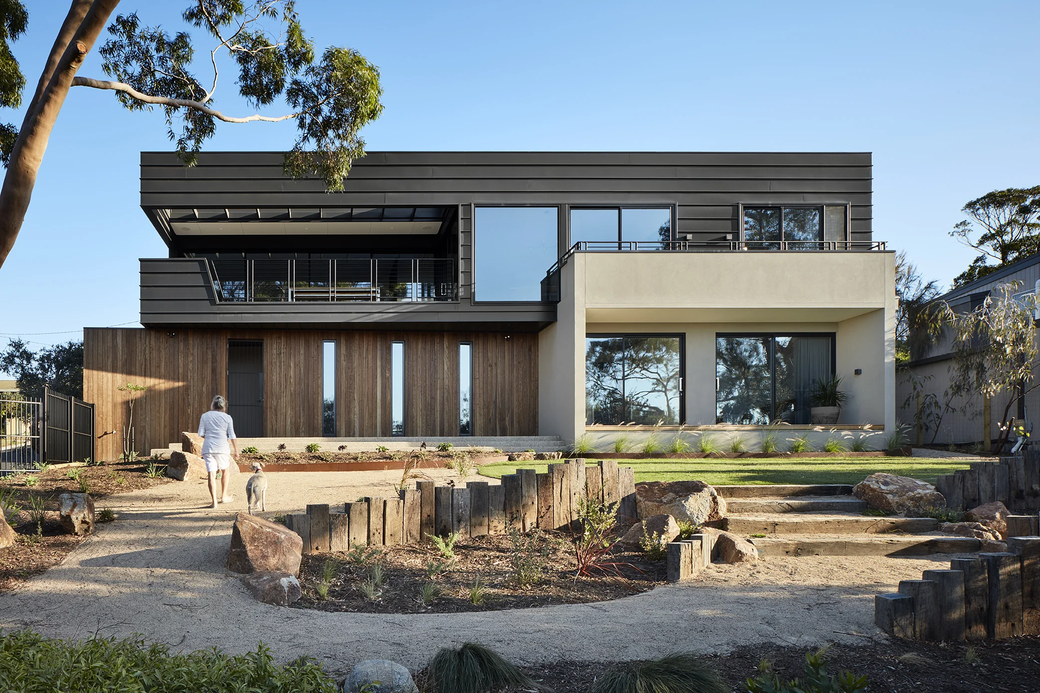 Our clients wanted a new house on a bayside site with views across Port Phillip Bay to the city. The building is contained to one edge of the site to maintain a strong connection with the existing landscape, as well as taking advantage of the long-distance views. A sophisticated weekender, the first floor living reflects the clients love of food, wine and entertaining. The materials used are simple, clean and robust – designed to engage with the landscape as it grows and defines the property. The lower floor is internalised – the muted colour palette punctuated by a punch of green identifying the cellar which forms the core of the house. This colour is echoed in the first floor carpet as part of a lighter, airier assembly of materials and colours.