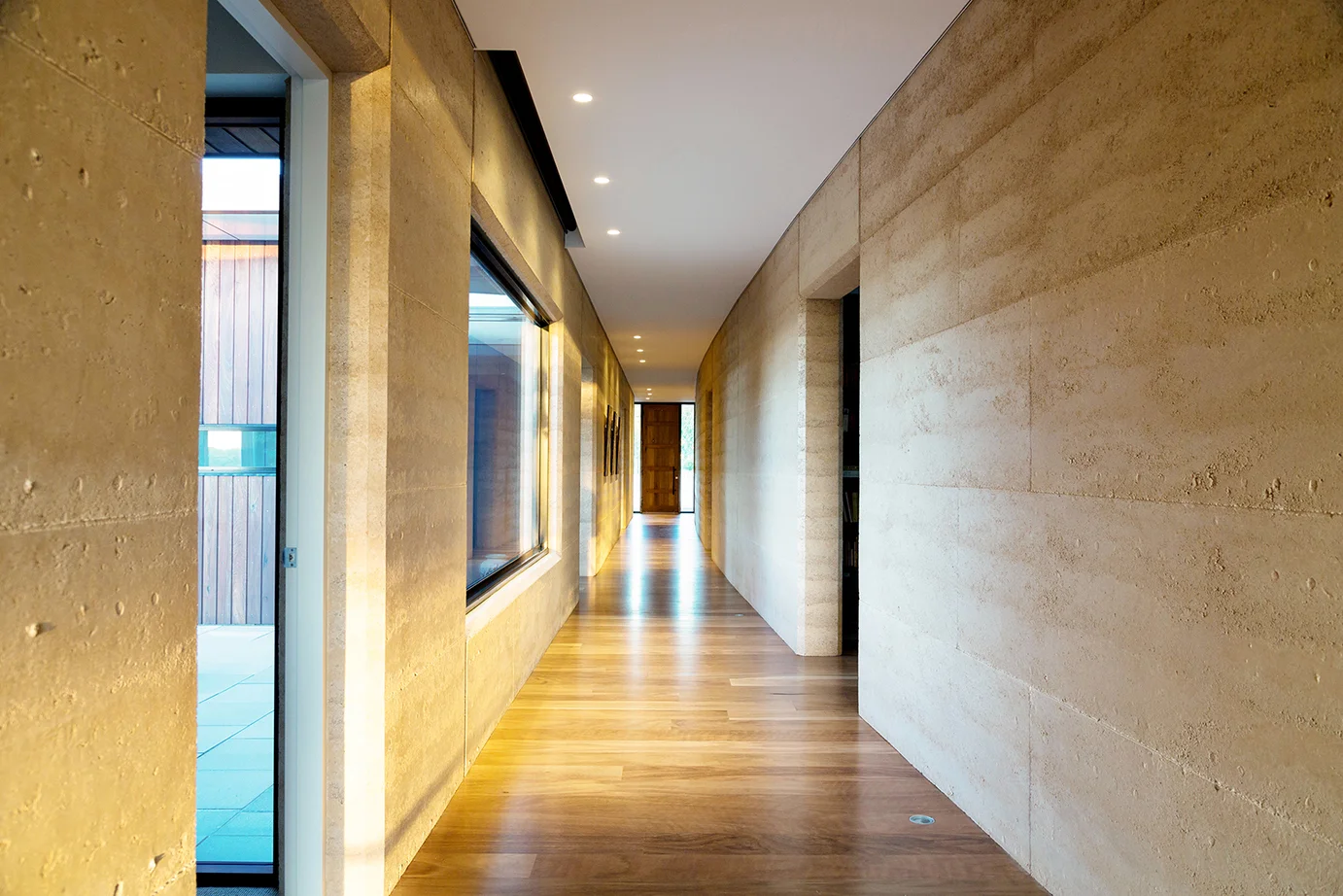 The owners had purchased this greenfield site, with the desire to build an eco-friendly, contemporary home. Locally sourced, structural earth walls create a feeling of gravity and warmth . The scheme was developed and evolved in close consultation with the owners. The design maximises the northern views, and is carefully considers the immediate landscape. The sustainable design utilises passive solar access, thermal mass, water harvesting and re-use, and geothermal heating/cooling.
