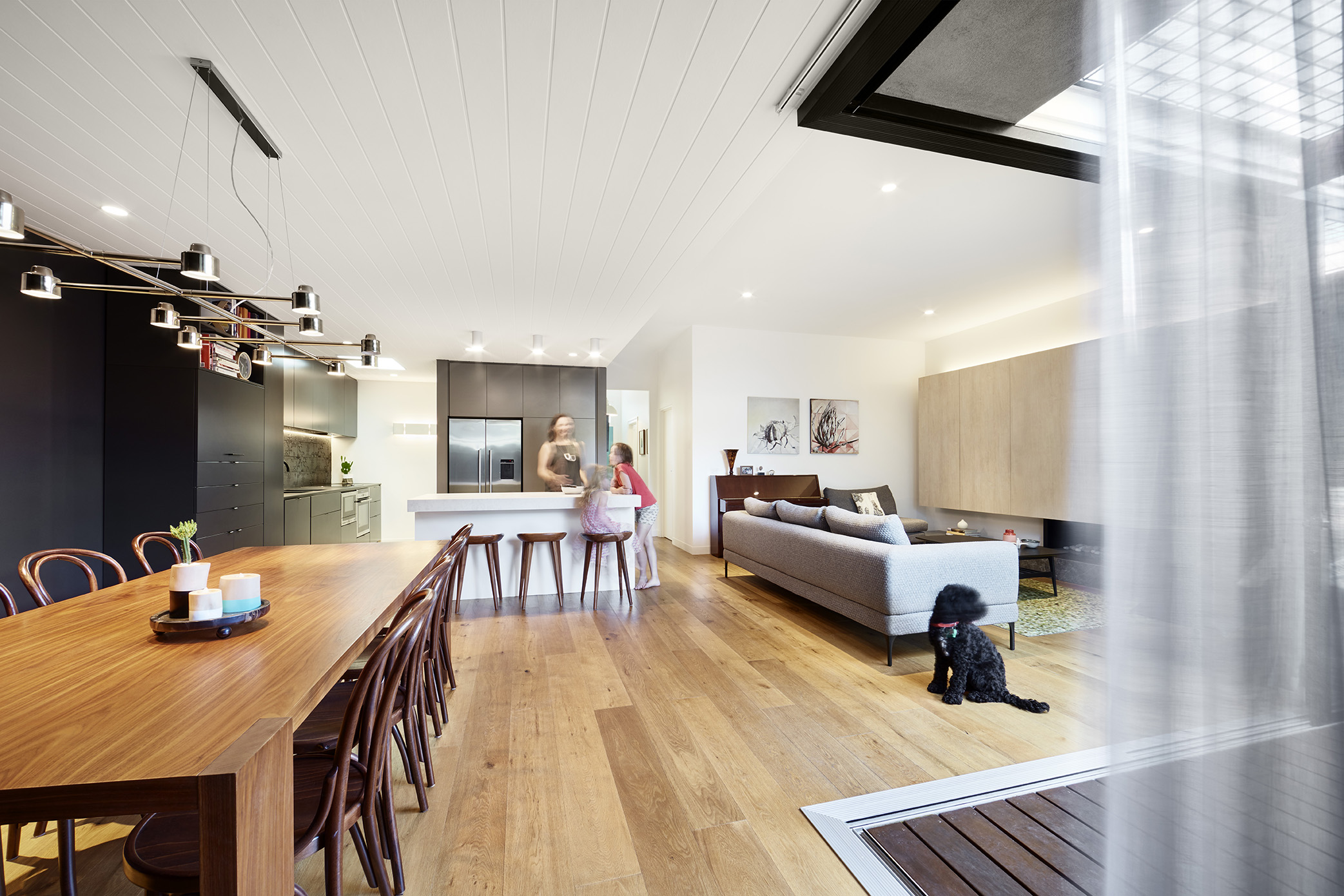 Strong, restrained colours and materials define spaces and the north-facing sliding doors connect to the deck and outdoor area – effectively tripling the living space.