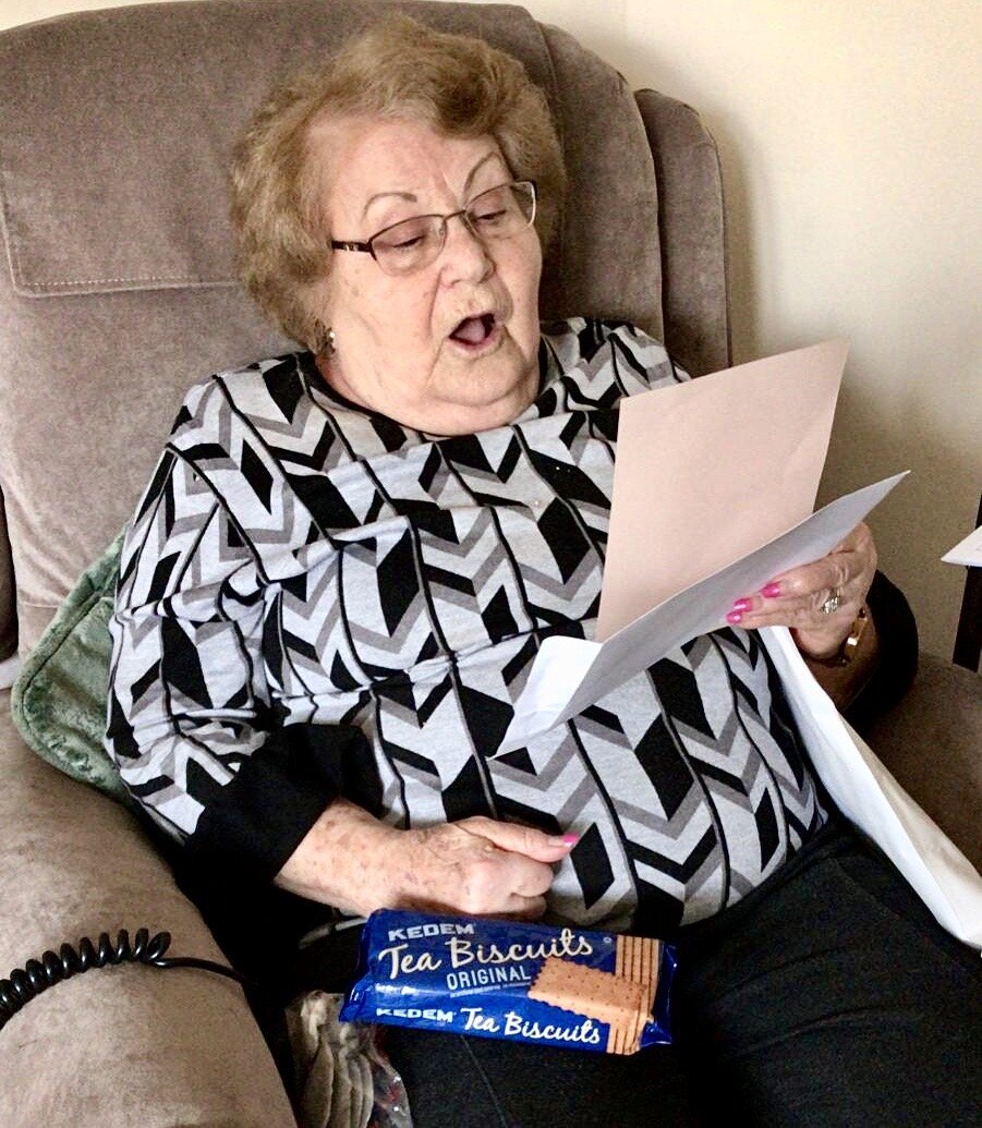 Eva Behar reading the note from her care package. Eva is a survivor of Auschwitz and Belsen..JPG