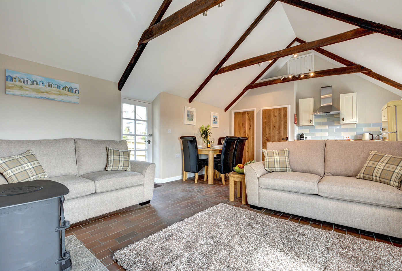 The lounge and dining area of Otterbridge luxury self catering converted barn holiday cottage at Penrose Burden in North Cornwall.jpg