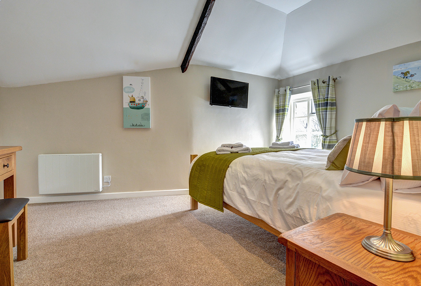 The second bedroom of Otterbridge luxury self catering converted barn holiday cottage at Penrose Burden in North Cornwall02.jpg