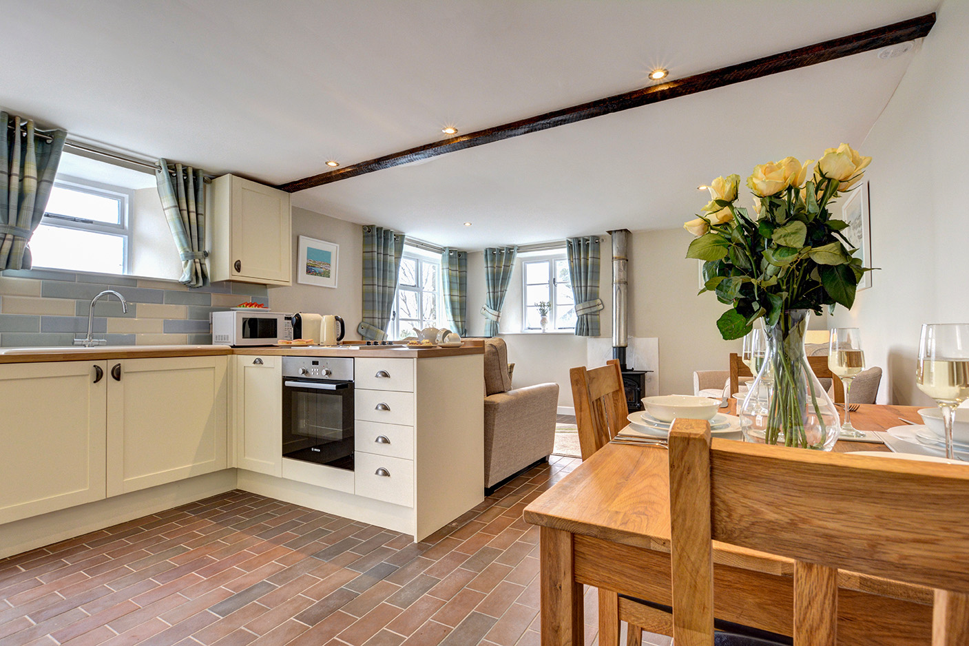 The dining area and kitchen of Butterwell luxury self catering converted barn holiday cottage at Penrose Burden in North Cornwall 01.jpg