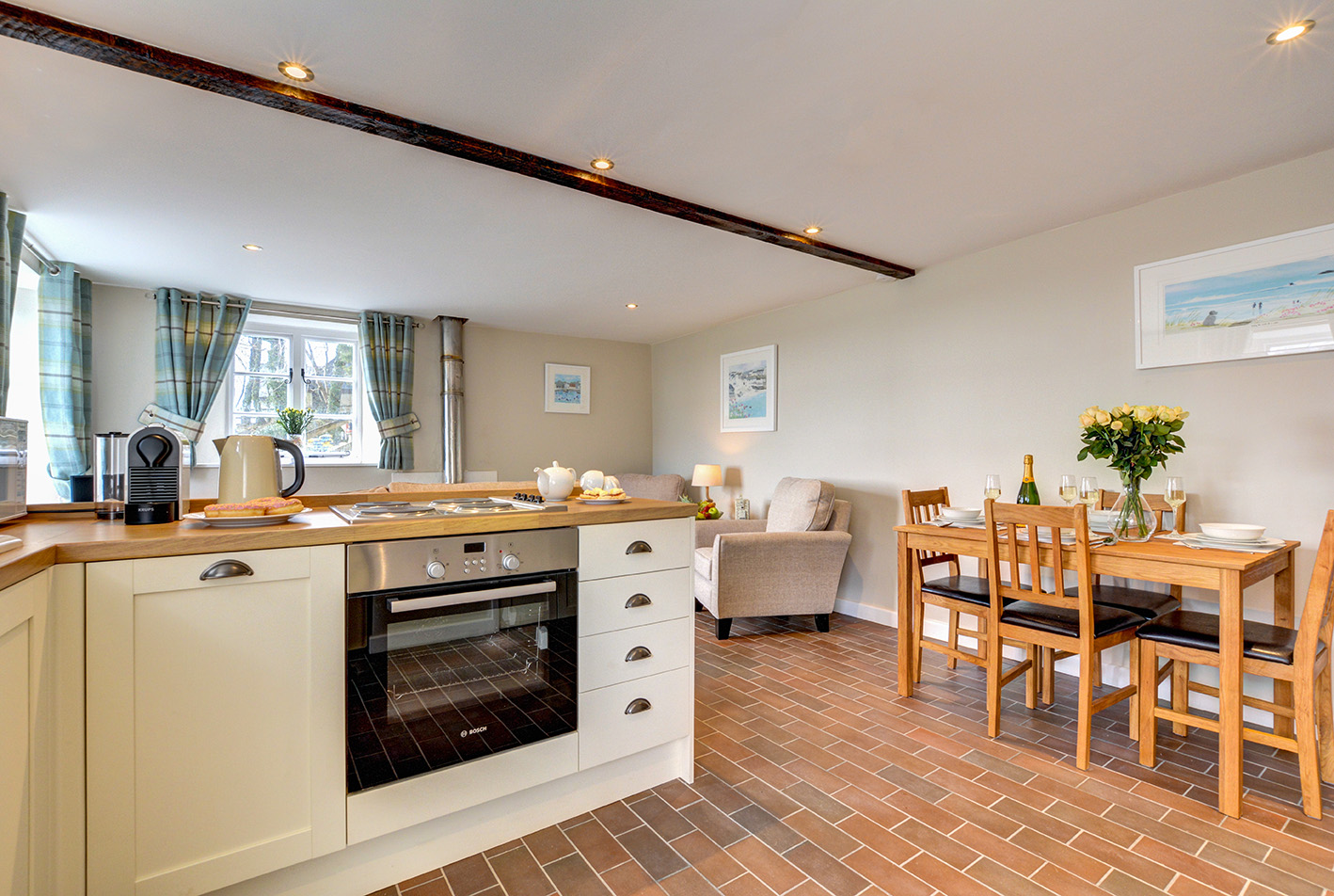The dining area and kitchen of Butterwell luxury self catering converted barn holiday cottage at Penrose Burden in North Cornwall 02.jpg