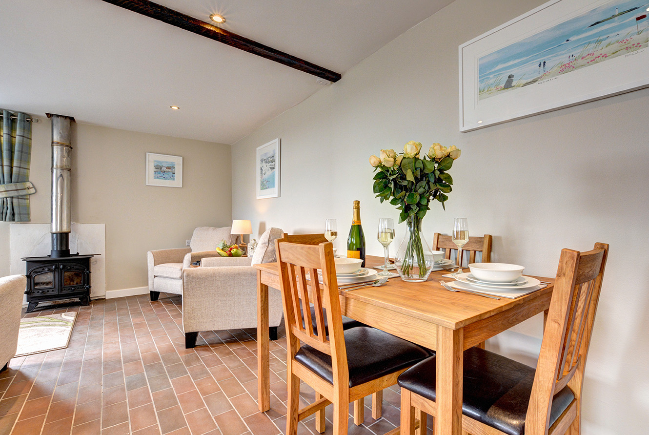 The dining area of Butterwell luxury self catering converted barn holiday cottage at Penrose Burden in North Cornwall 01.jpg