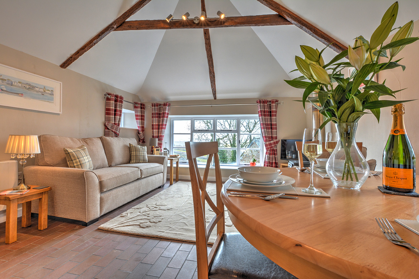 The dining and lounge area of Goosehill luxury self catering converted barn holiday cottage at Penrose Burden in North Cornwall 01.jpg