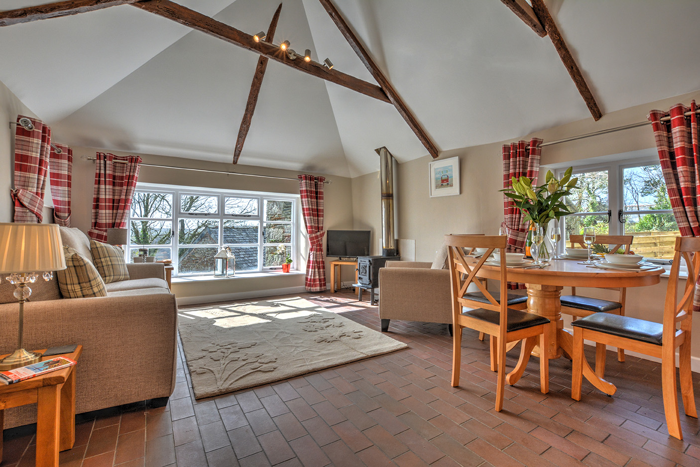 The dining and lounge area of Goosehill luxury self catering converted barn holiday cottage at Penrose Burden in North Cornwall 02.jpg