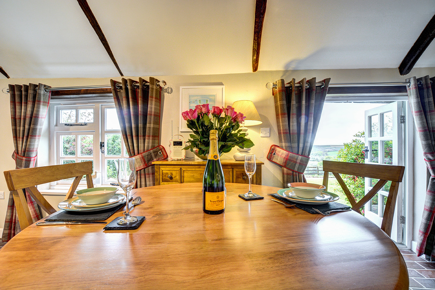 The dining area of The Linney self catering cottage converted barn at Penrose Burden holiday cottages in Cornwall.jpg