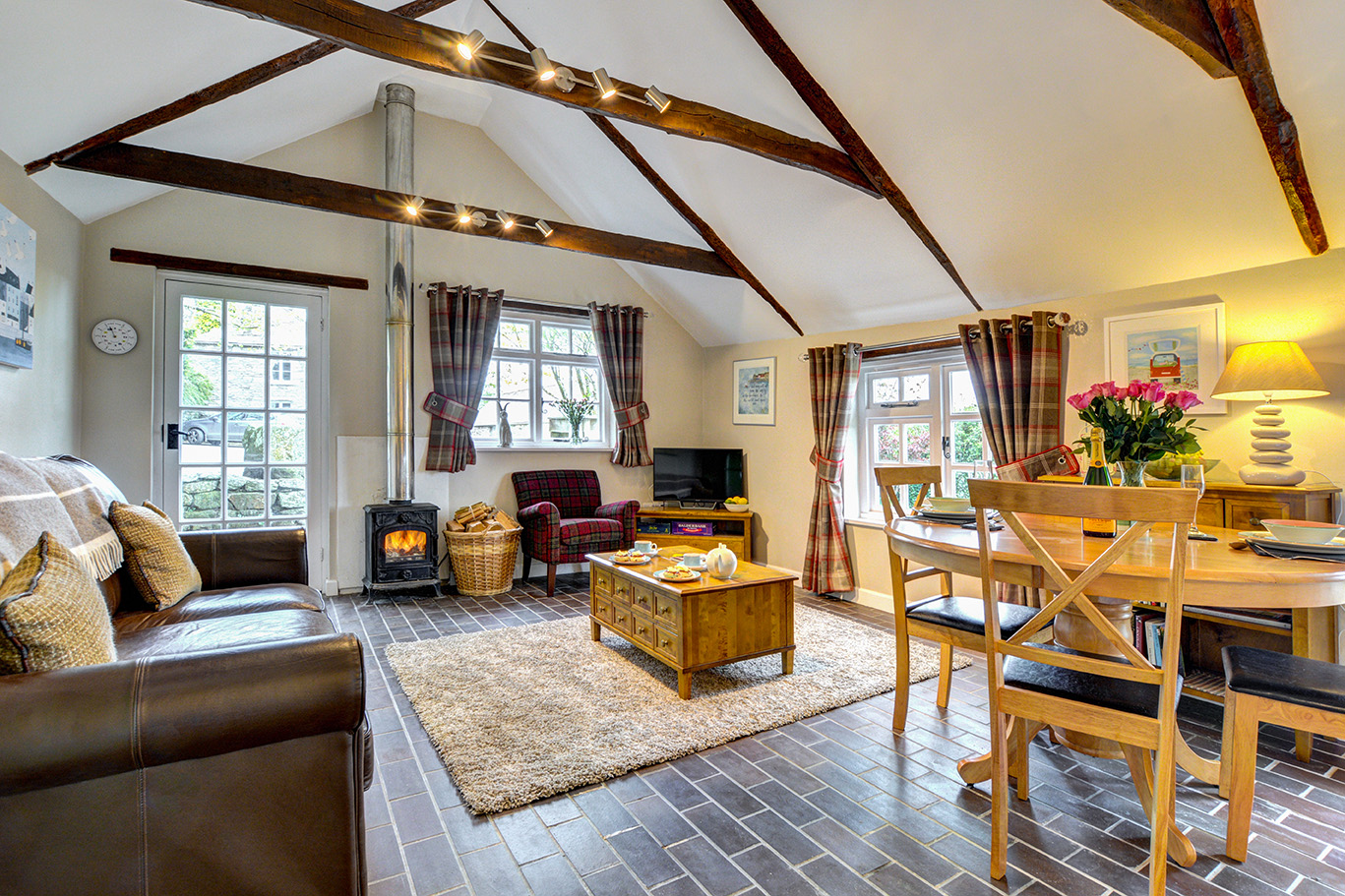 The lounge and dining area of The Linney self catering cottage converted barn at Penrose Burden holiday cottages in Cornwall.jpg