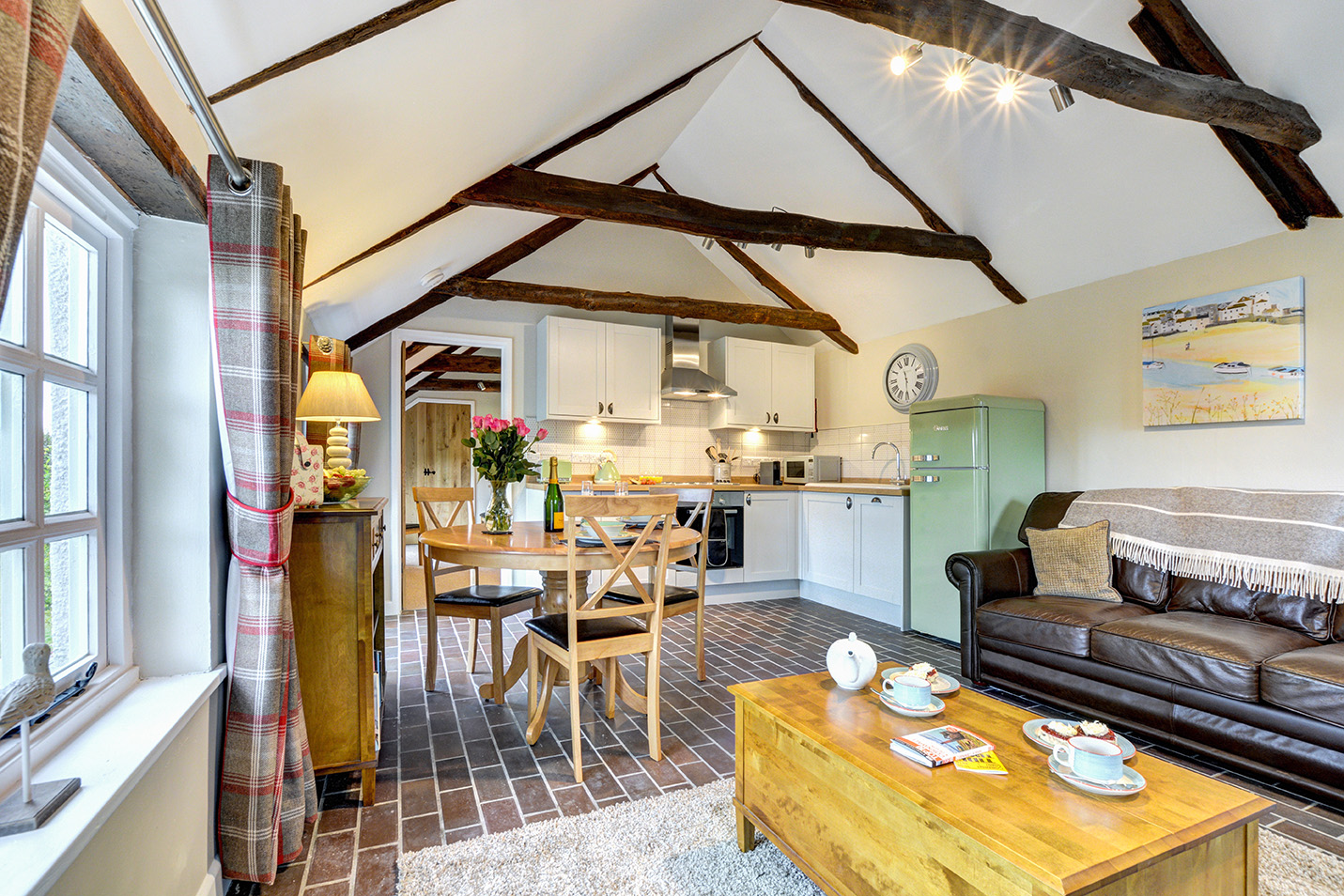 The lounge diner kitchen of The Linney self catering cottage converted barn at Penrose Burden holiday cottages in Cornwall 01.jpg