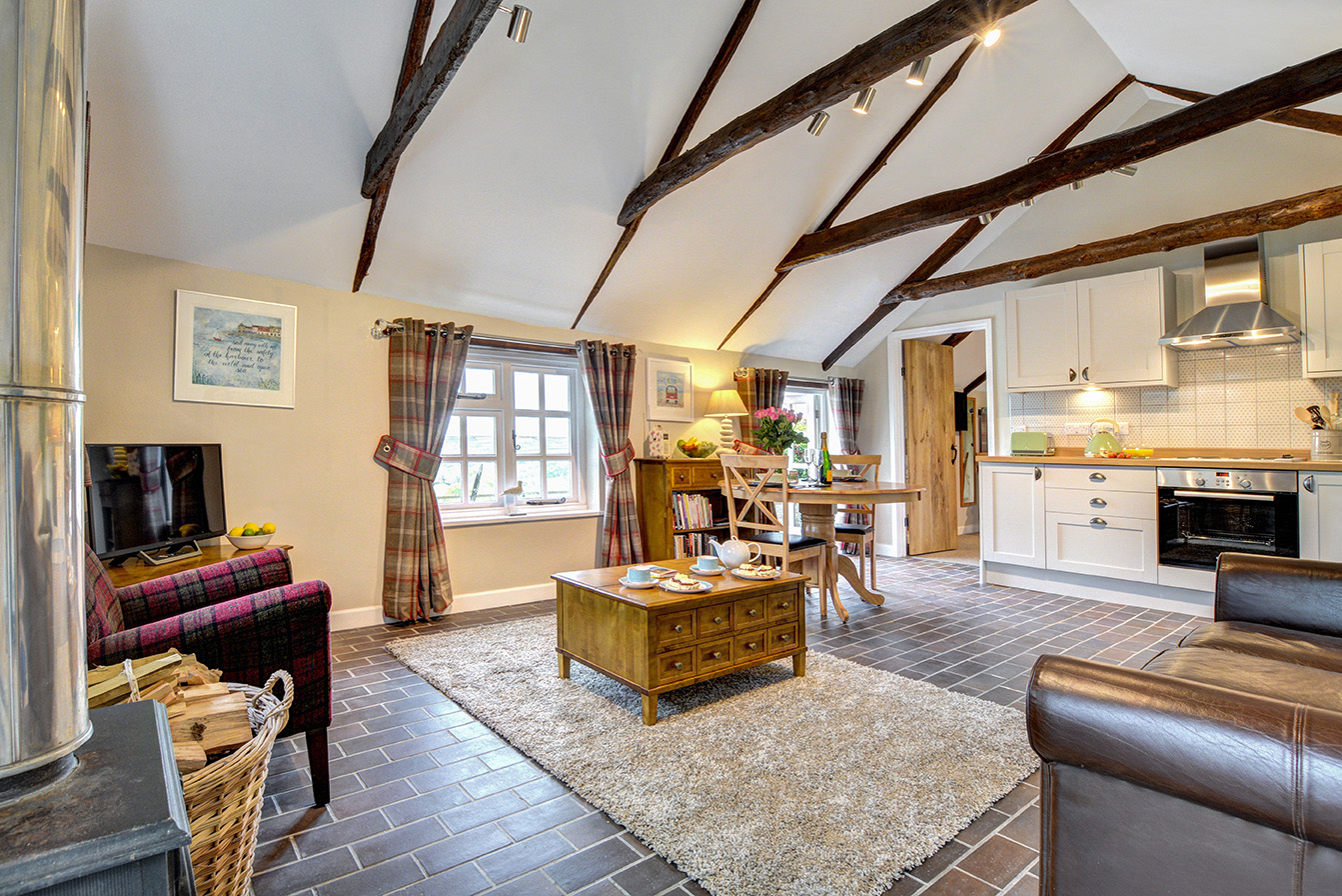 The lounge diner kitchen of The Linney self catering cottage converted barn at Penrose Burden holiday cottages in Cornwall.jpg