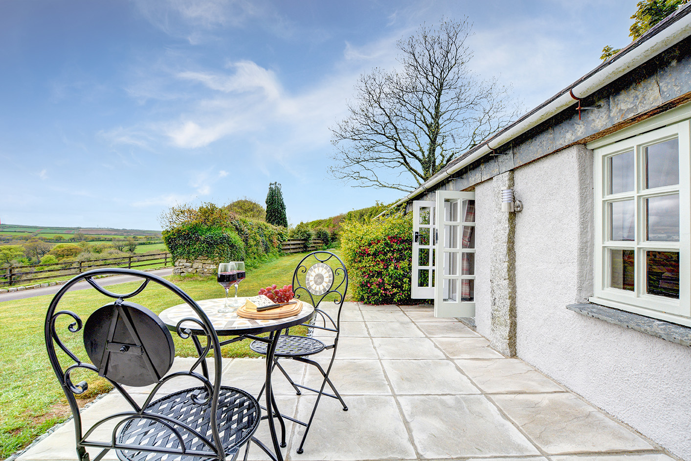 The outside and patio area of The Linney self catering cottage converted barn at Penrose Burden holiday cottages in Cornwall.jpg