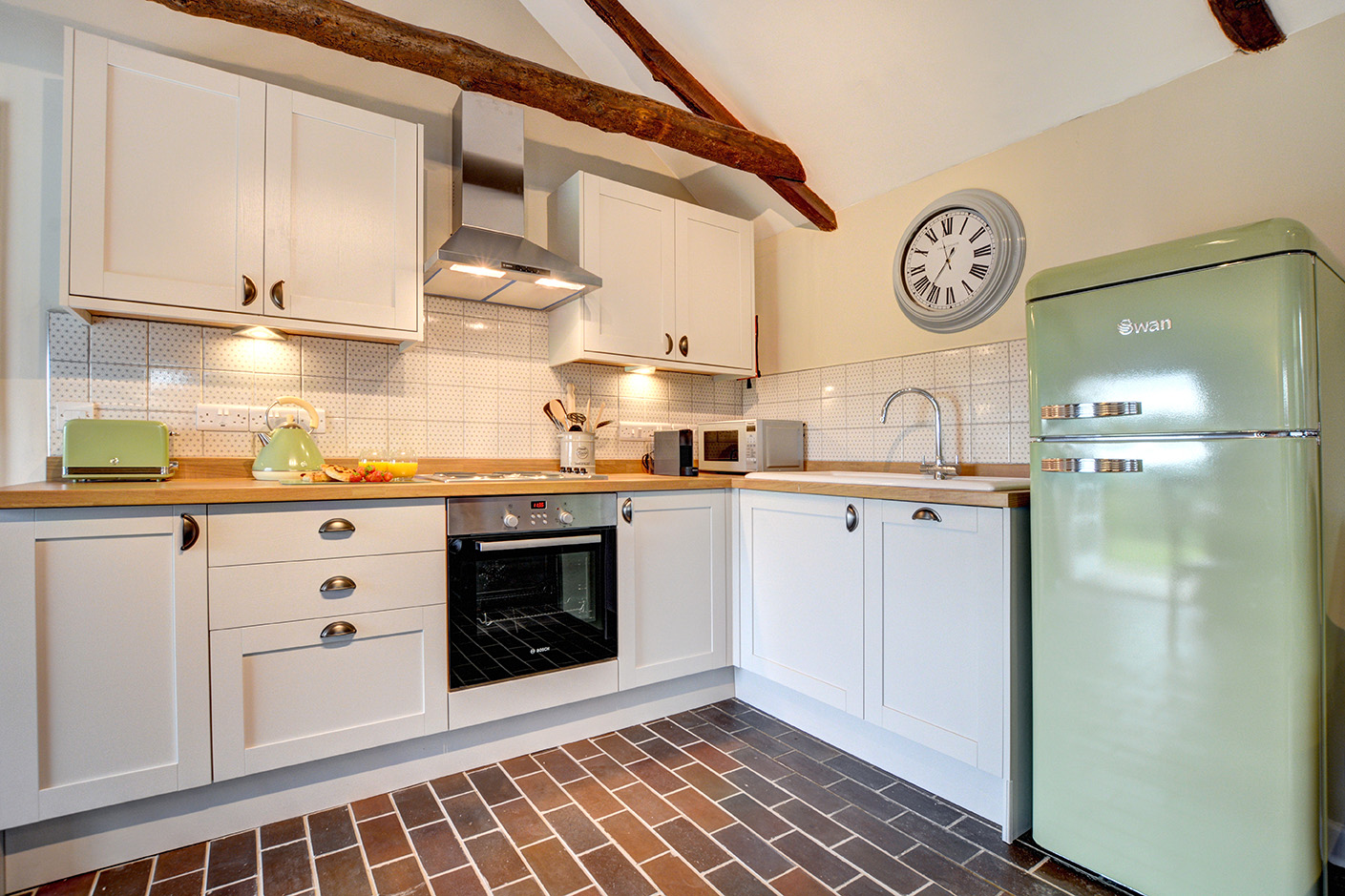 The kitchen area of The Linney self catering cottage converted barn at Penrose Burden holiday cottages in Cornwall.jpg