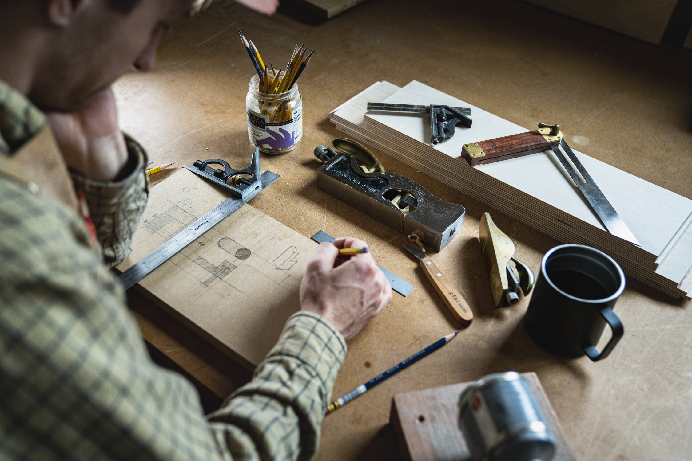 Environmental Portrait of Casey Chandler designing a wooden latch in Santa Cruz, CA