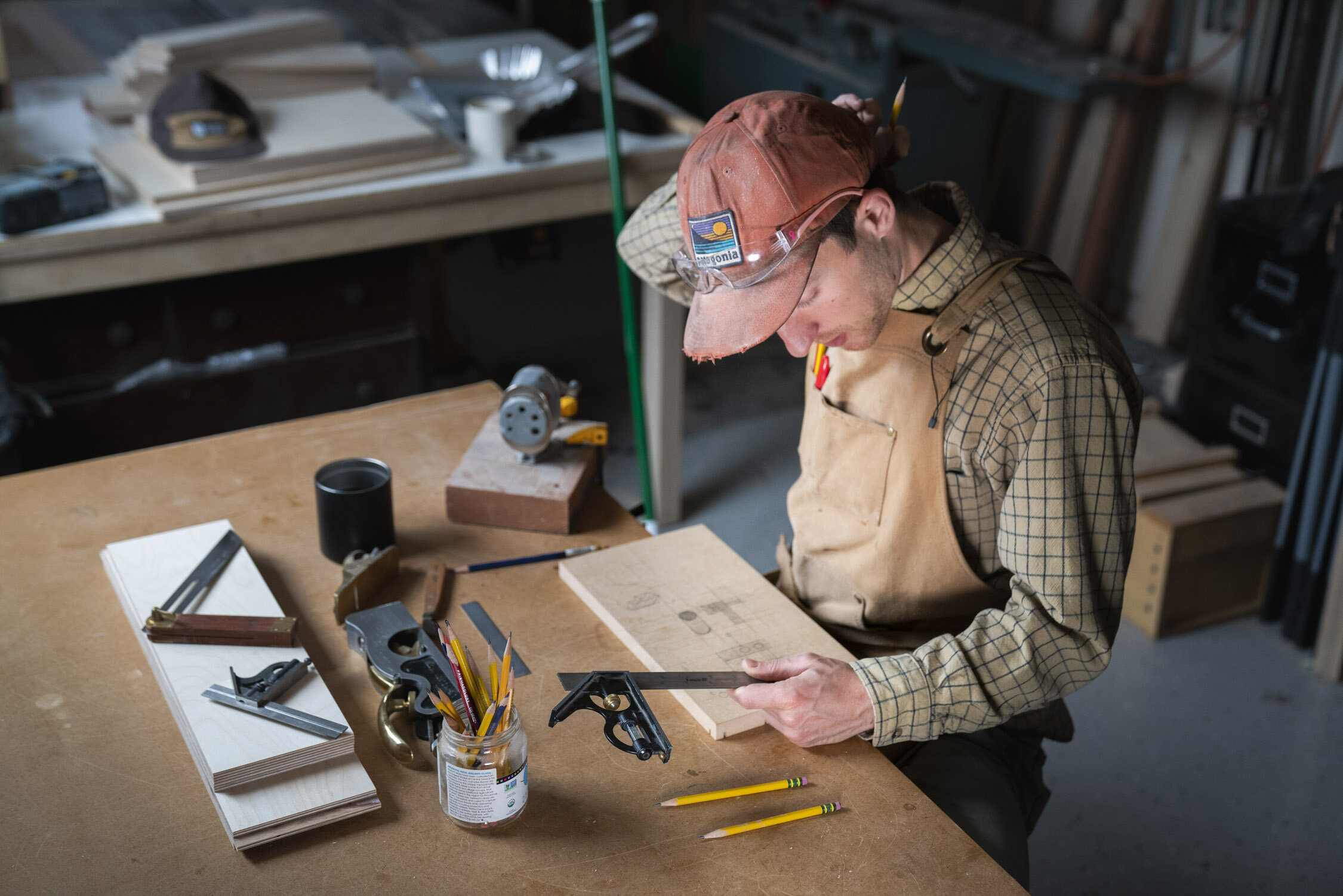 Environmental Portrait of Casey Chandler designing a wooden latch in Santa Cruz, CA