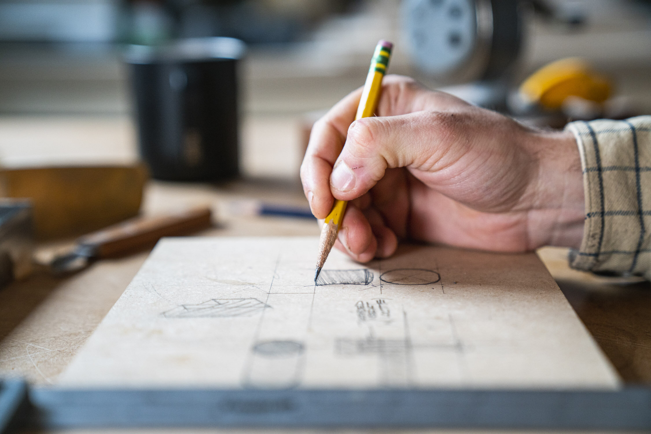 Environmental Portrait of Casey Chandler designing a wooden latch in Santa Cruz, CA