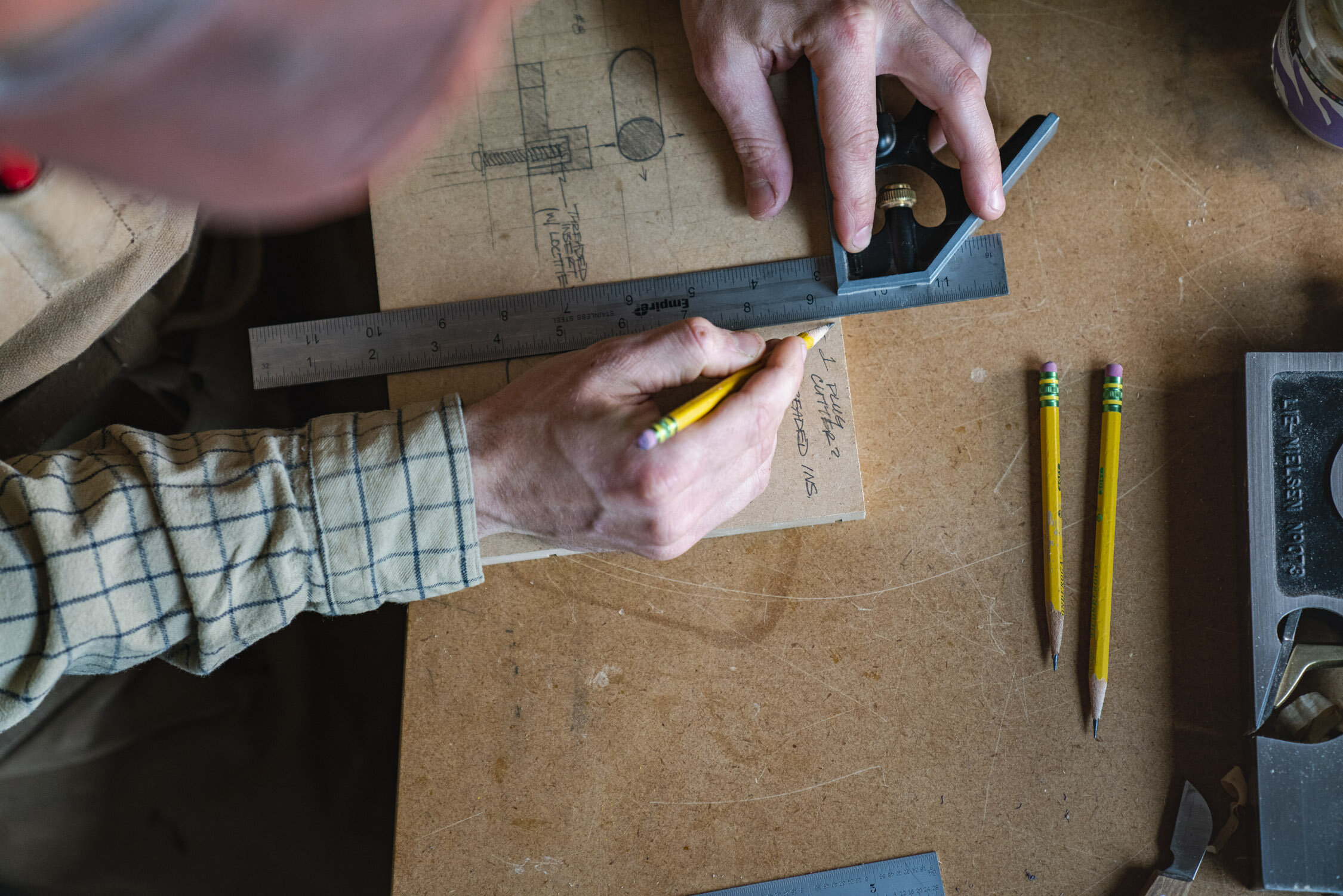 Environmental Portrait of Casey Chandler designing a wooden latch in Santa Cruz, CA