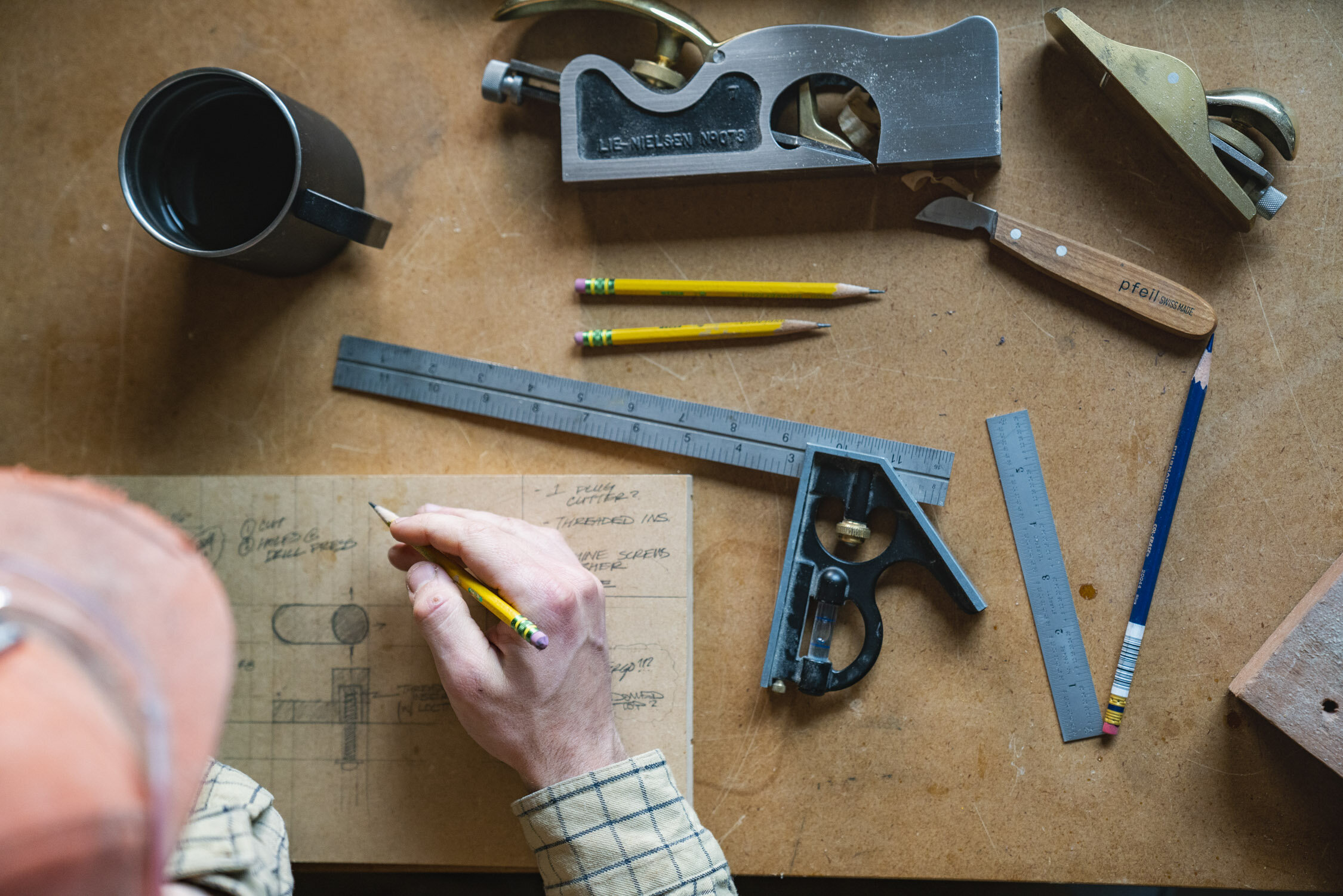 Environmental Portrait of Casey Chandler designing a wooden latch in Santa Cruz, CA