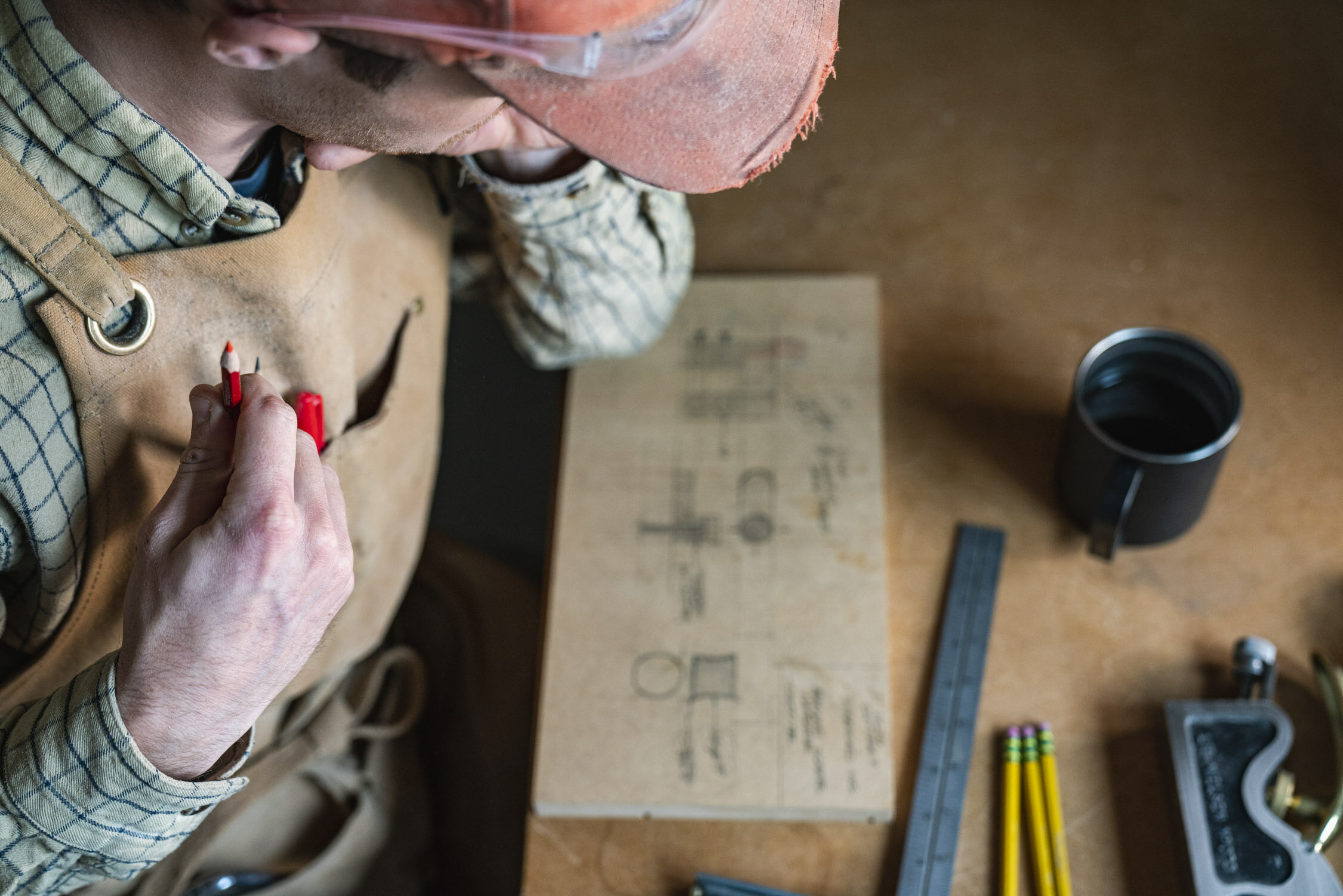 Environmental Portrait of Casey Chandler designing a wooden latch in Santa Cruz, CA