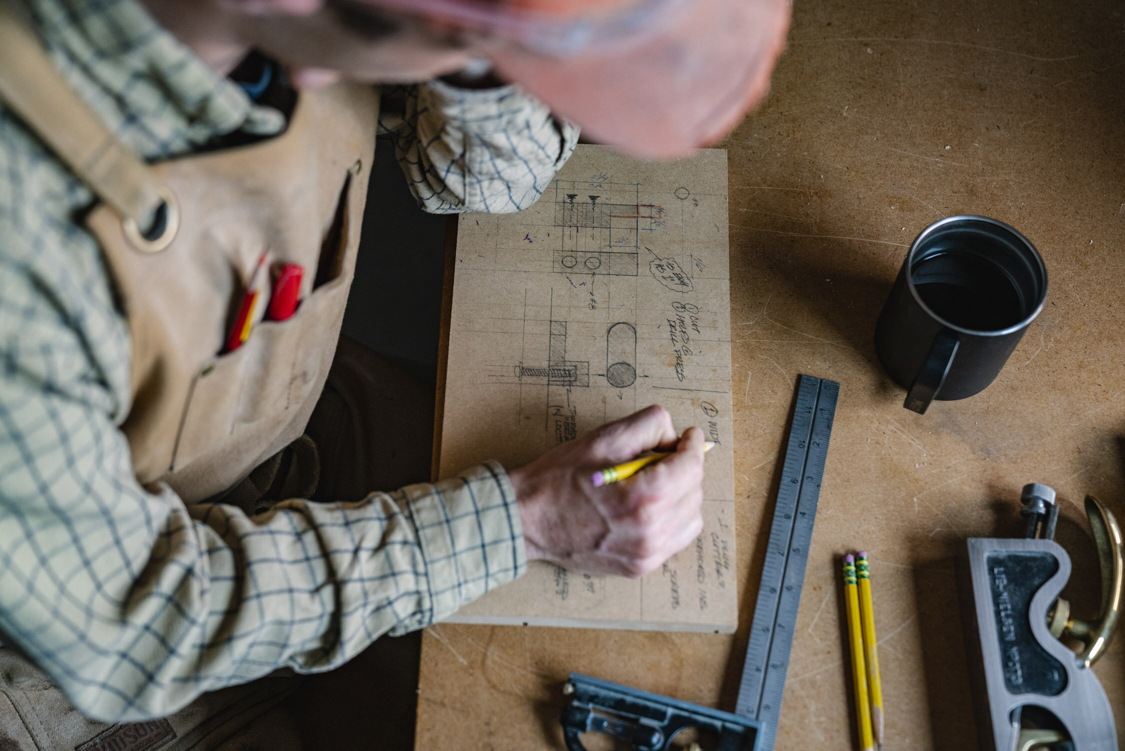 Environmental Portrait of Casey Chandler designing a wooden latch in Santa Cruz, CA