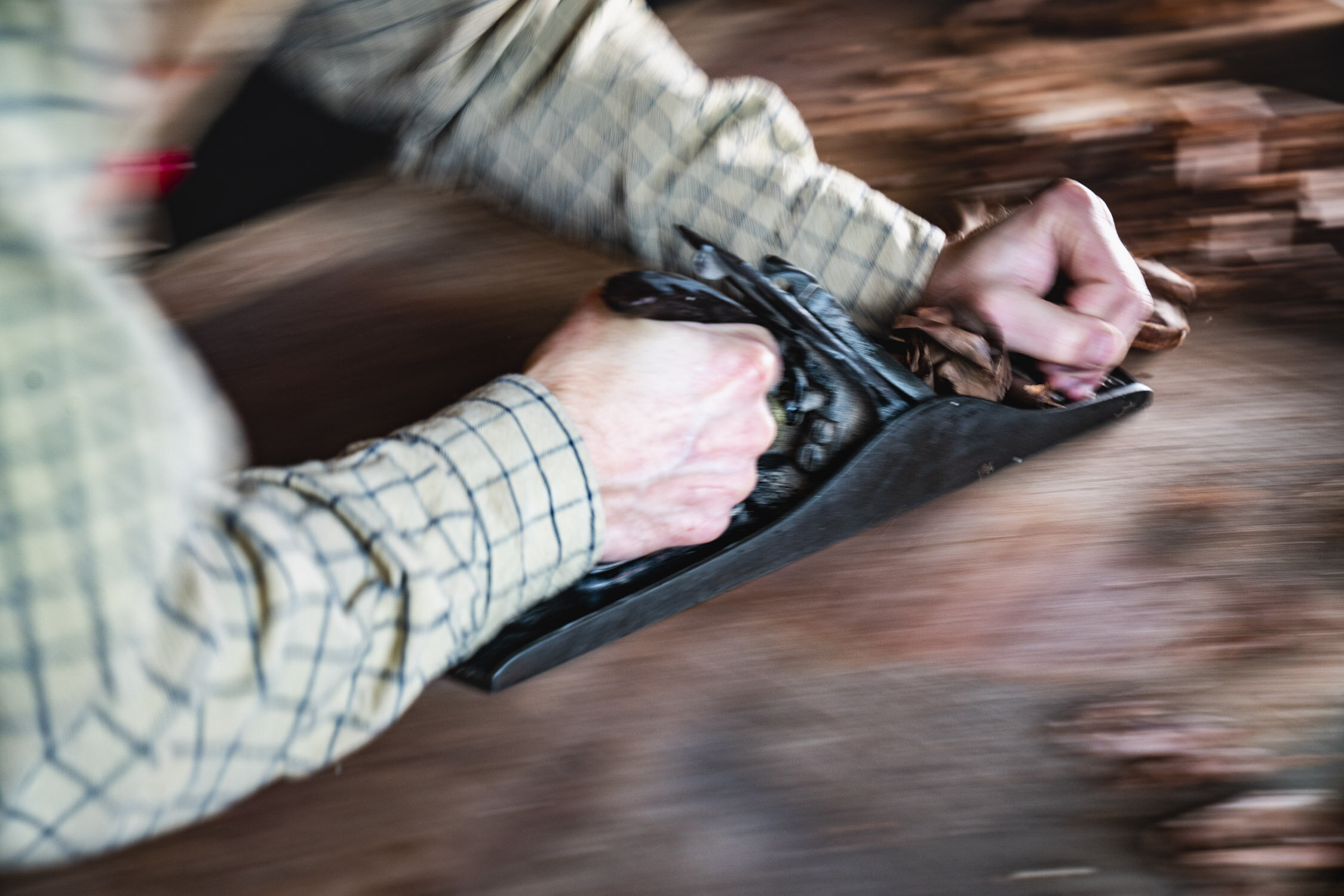 Environmental Portrait of Casey Chandler designing a wooden latch in Santa Cruz, CA