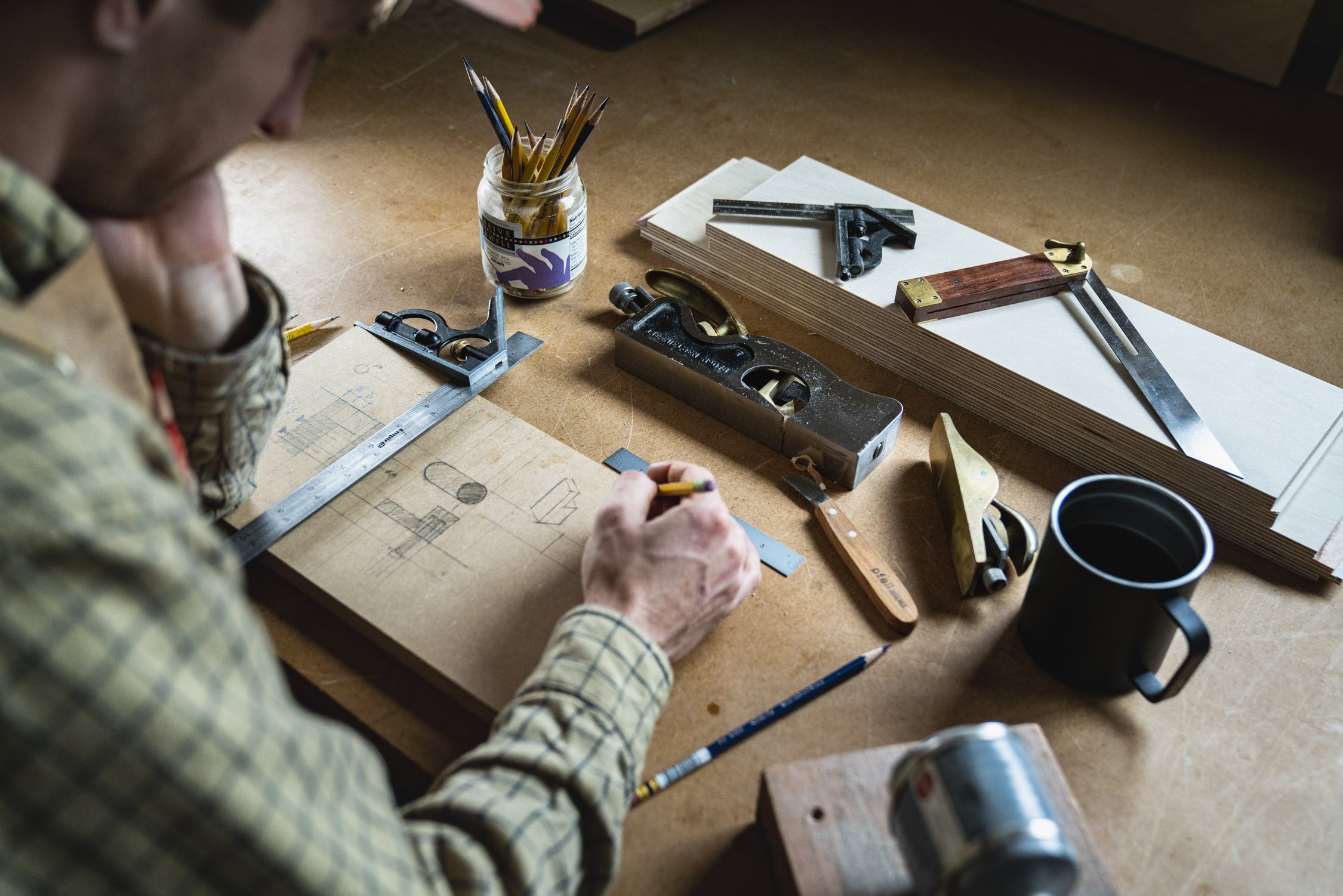 Environmental Portrait of Casey Chandler designing a wooden latch in Santa Cruz, CA
