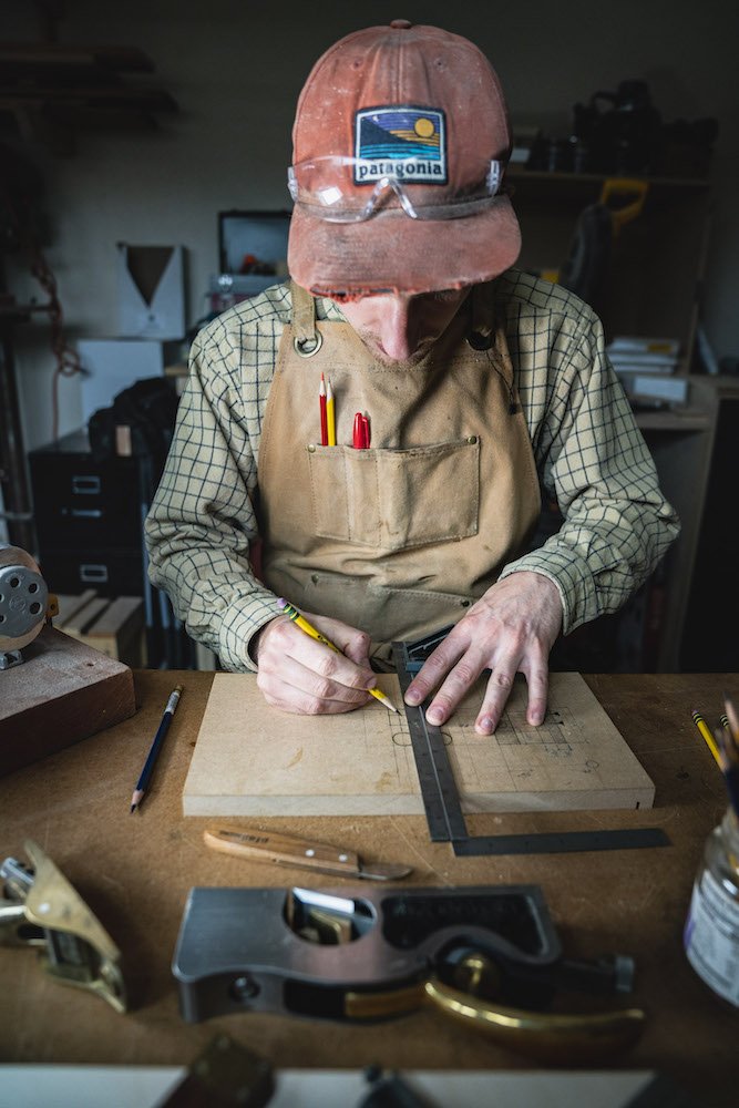 Environmental Portrait of Casey Chandler designing a wooden latch in Santa Cruz, CA