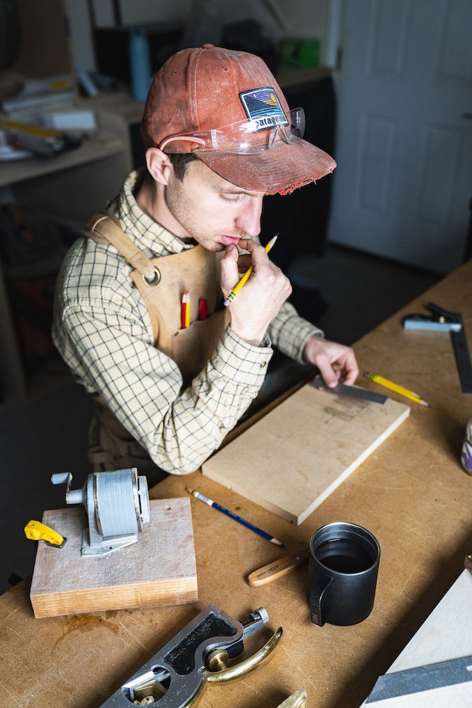 Environmental Portrait of Casey Chandler designing a wooden latch in Santa Cruz, CA