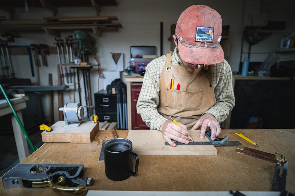 Environmental Portrait of Casey Chandler designing a wooden latch in Santa Cruz, CA