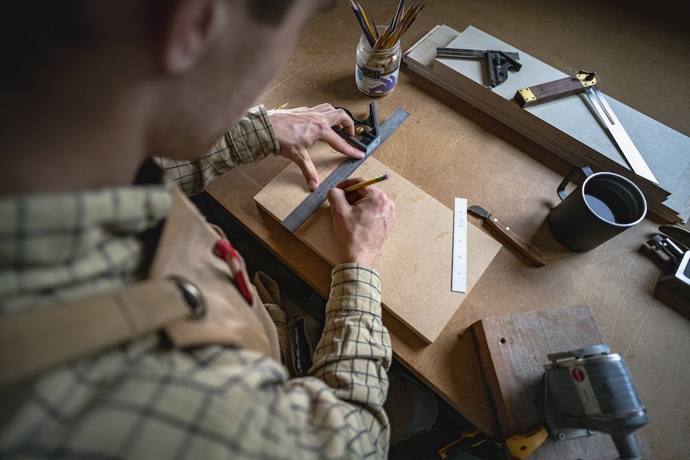 Environmental Portrait of Casey Chandler designing a wooden latch in Santa Cruz, CA