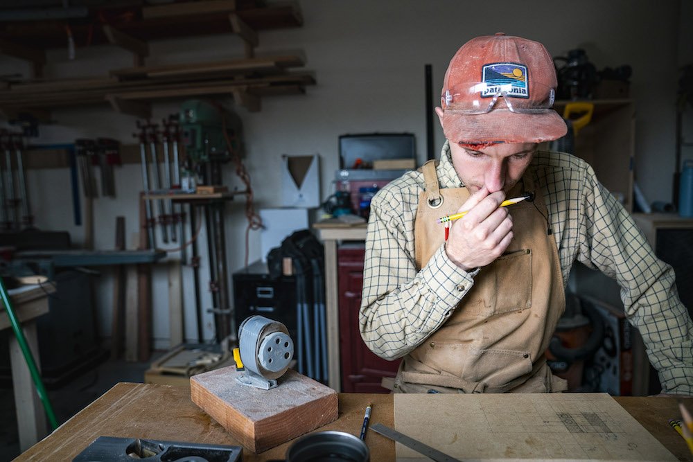 Environmental Portrait of Casey Chandler designing a wooden latch in Santa Cruz, CA