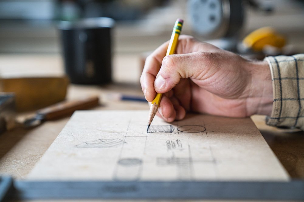 Environmental Portrait of Casey Chandler designing a wooden latch in Santa Cruz, CA