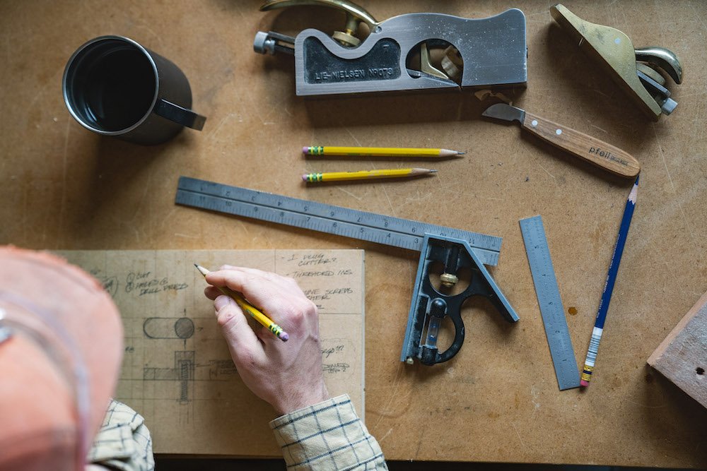 Environmental Portrait of Casey Chandler designing a wooden latch in Santa Cruz, CA