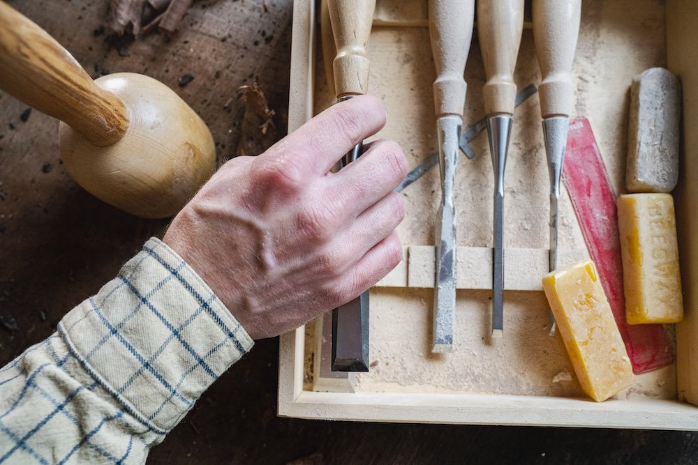 Environmental Portrait of Casey Chandler designing a wooden latch in Santa Cruz, CA