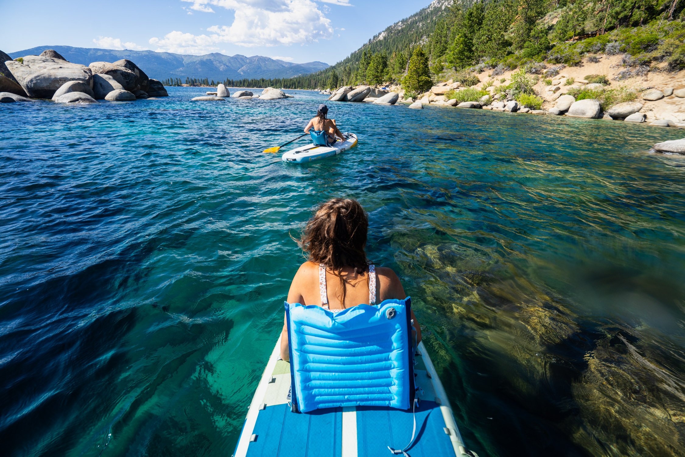 Adventure photographer, Dalton Johnson, captures a women and a man paddle boarding on Lake Tahoe using Crazy Creek seats
