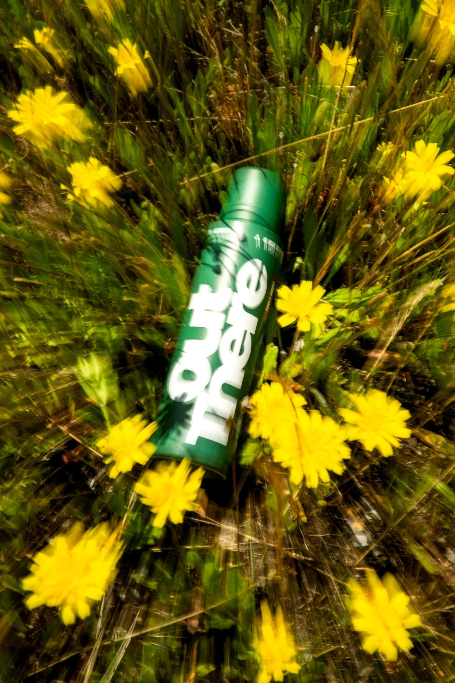  Adventure photographer, Dalton Johnson, photographs a bottle of spray deodorant by “Out There” in a field of flowers. 