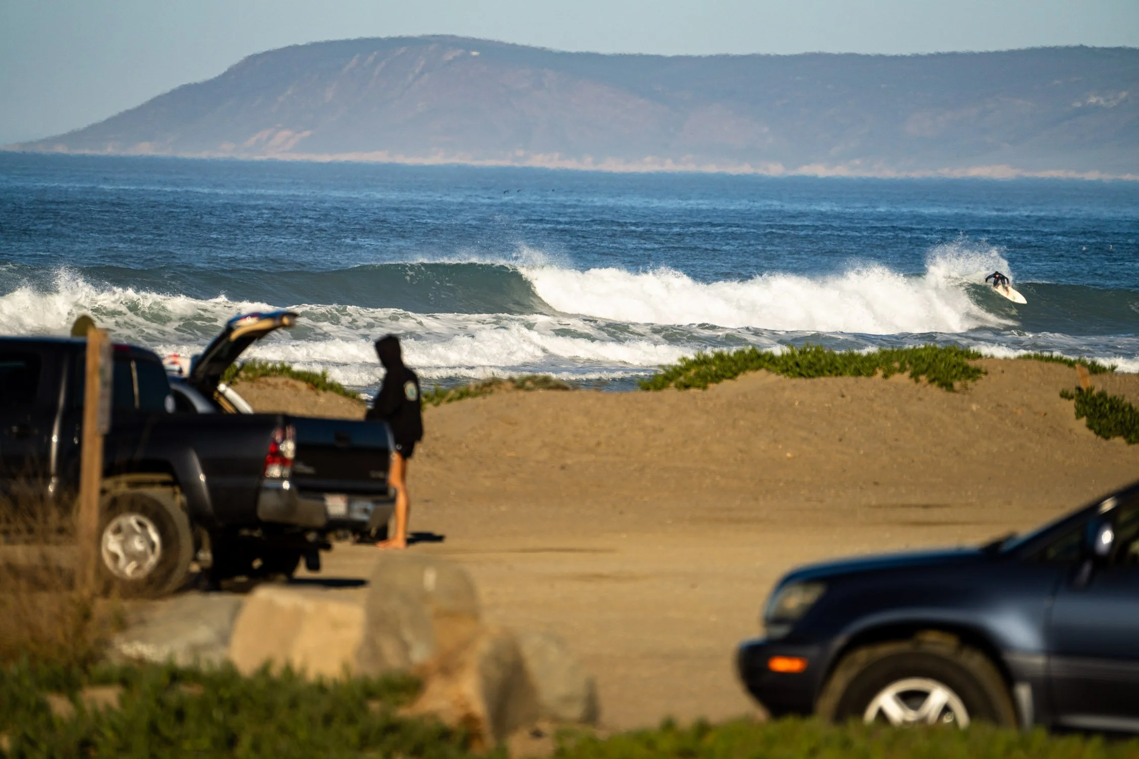 Adventure photographer, Dalton Johnson, captures an image of a surfer at Morro Rock