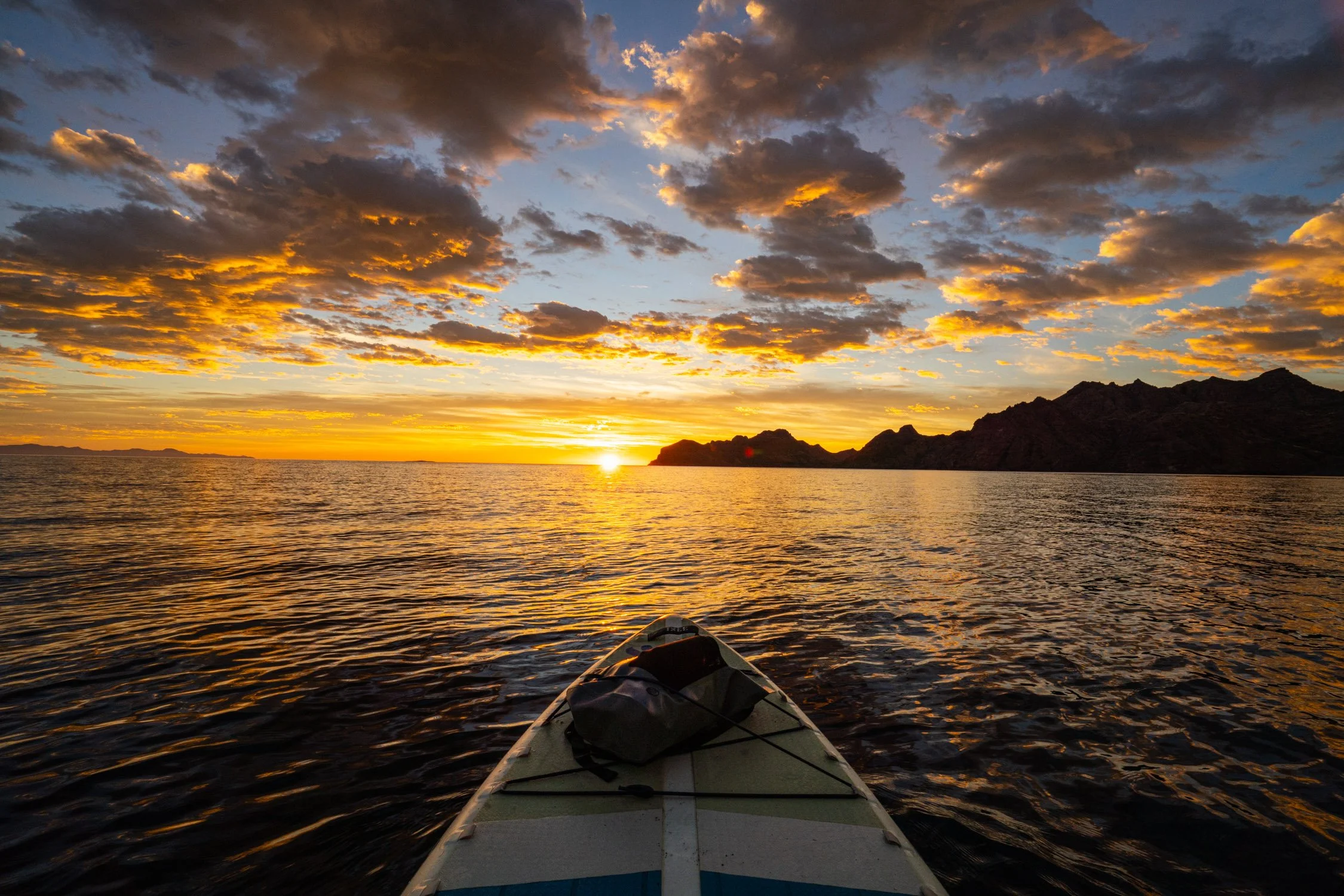 Adventure photographer Dalton Johnson captures a stunning sunrise on the ocean with a paddleboard and nite ize backpack