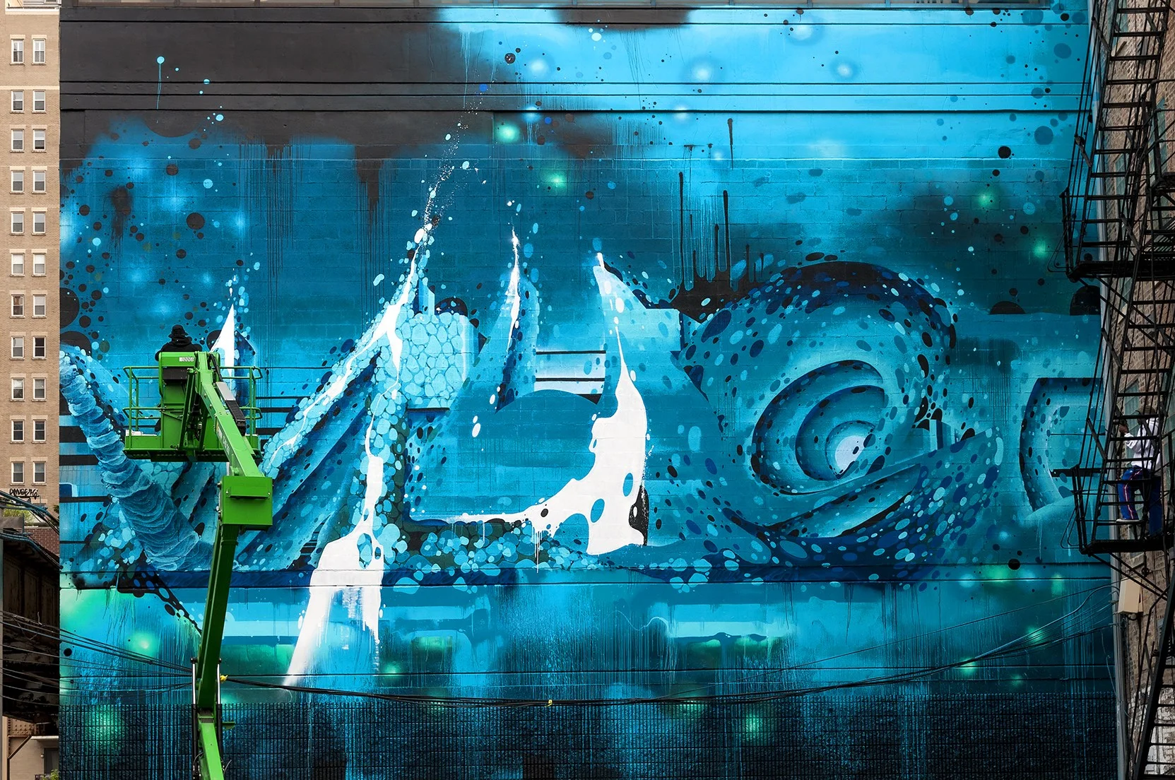 Shown is a mural by Amuse126 that lives on the North wall of our very own building.