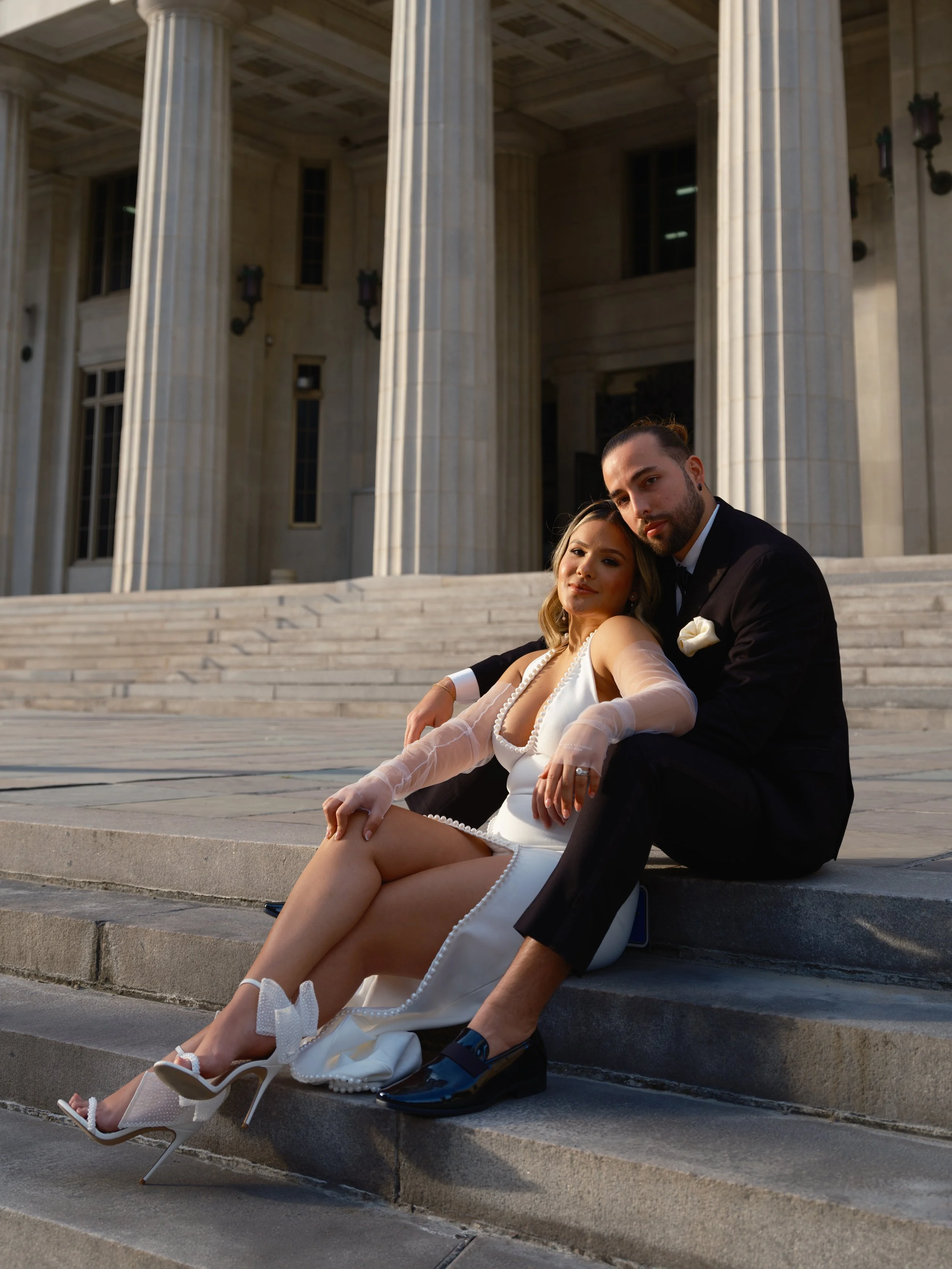 Couple seated on the steps of the historic courthouse in downtown Miami after their courthouse elopement