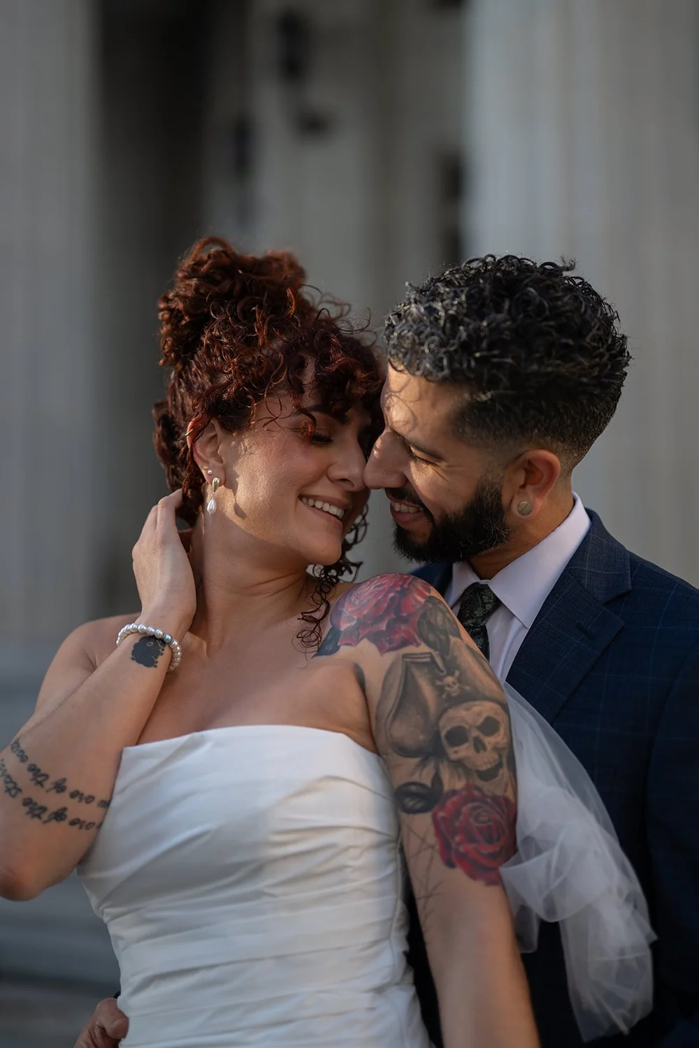 Close portrait of the bride and groom touching foreheads