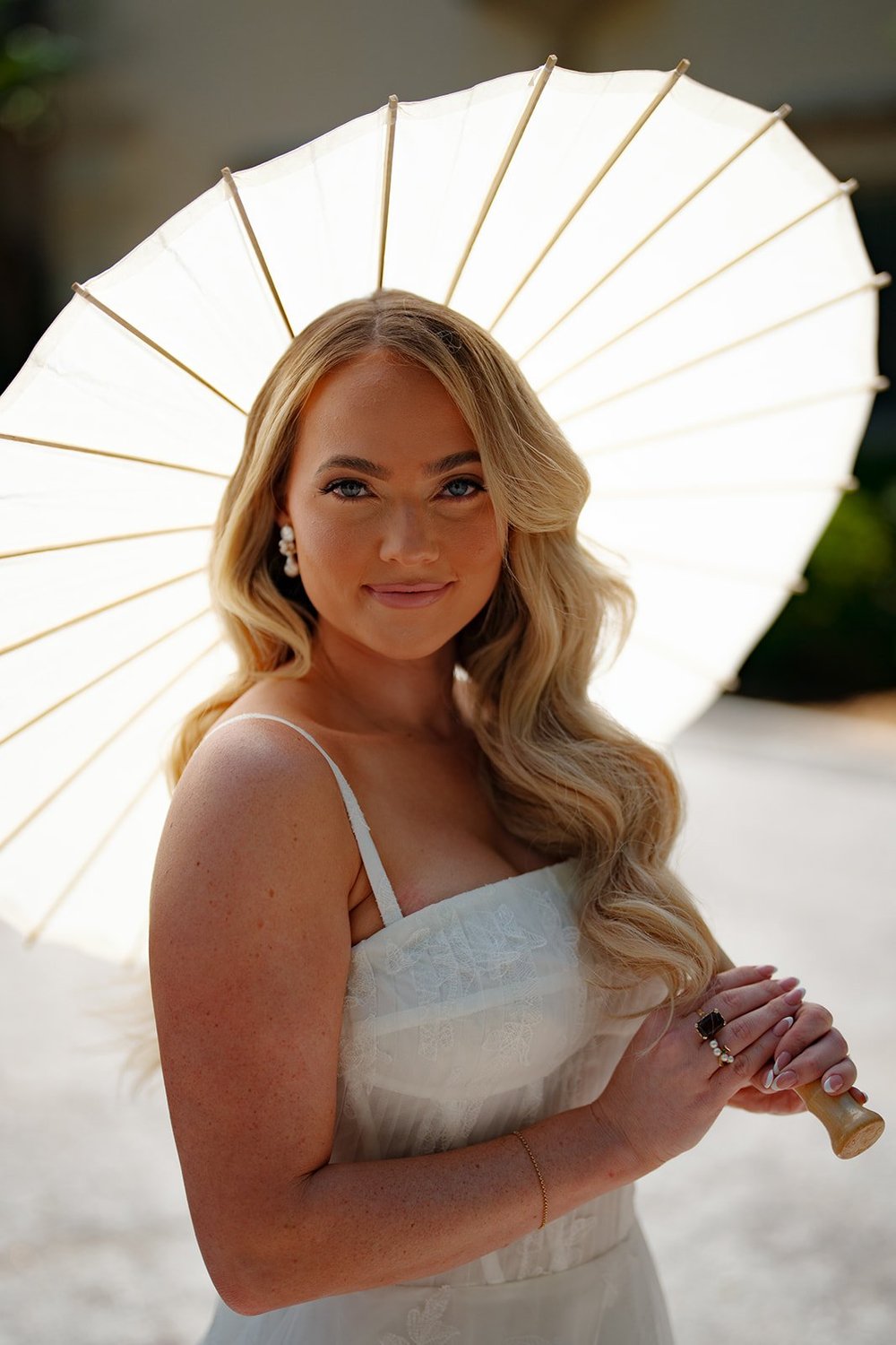 Portrait of Jane holding a white paper parasol in the sun