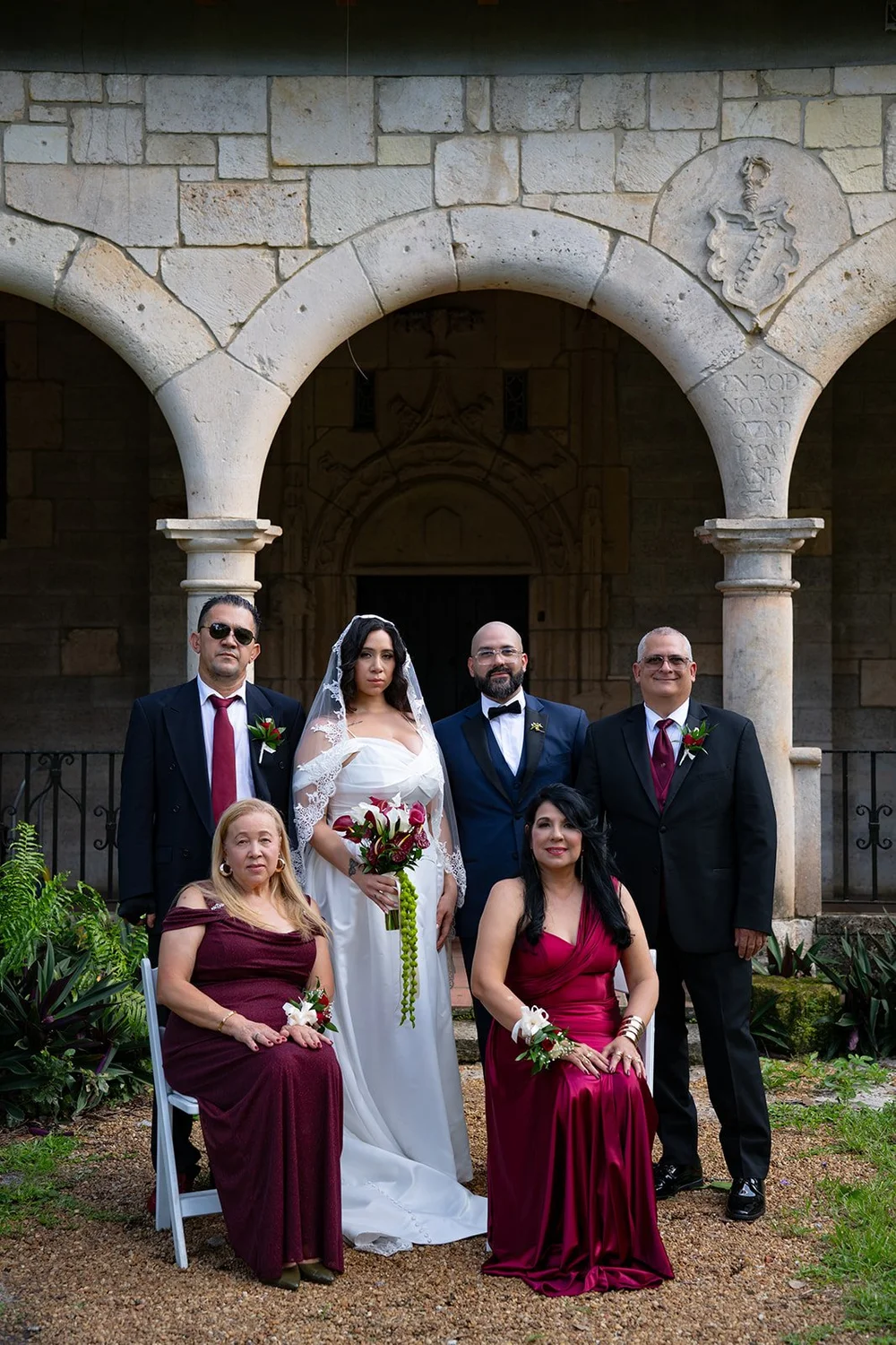 Group portrait of Maria, Christian and their family in front of the stone arches