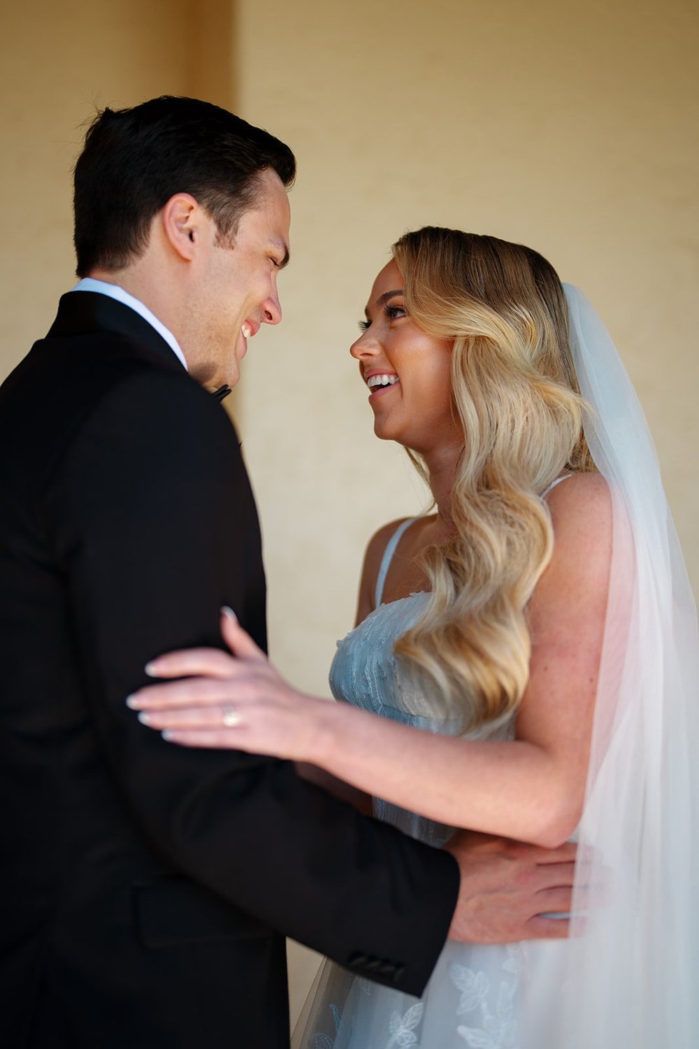 Jane and Berkeley smiling at each other with their foreheads close and her veil flowing