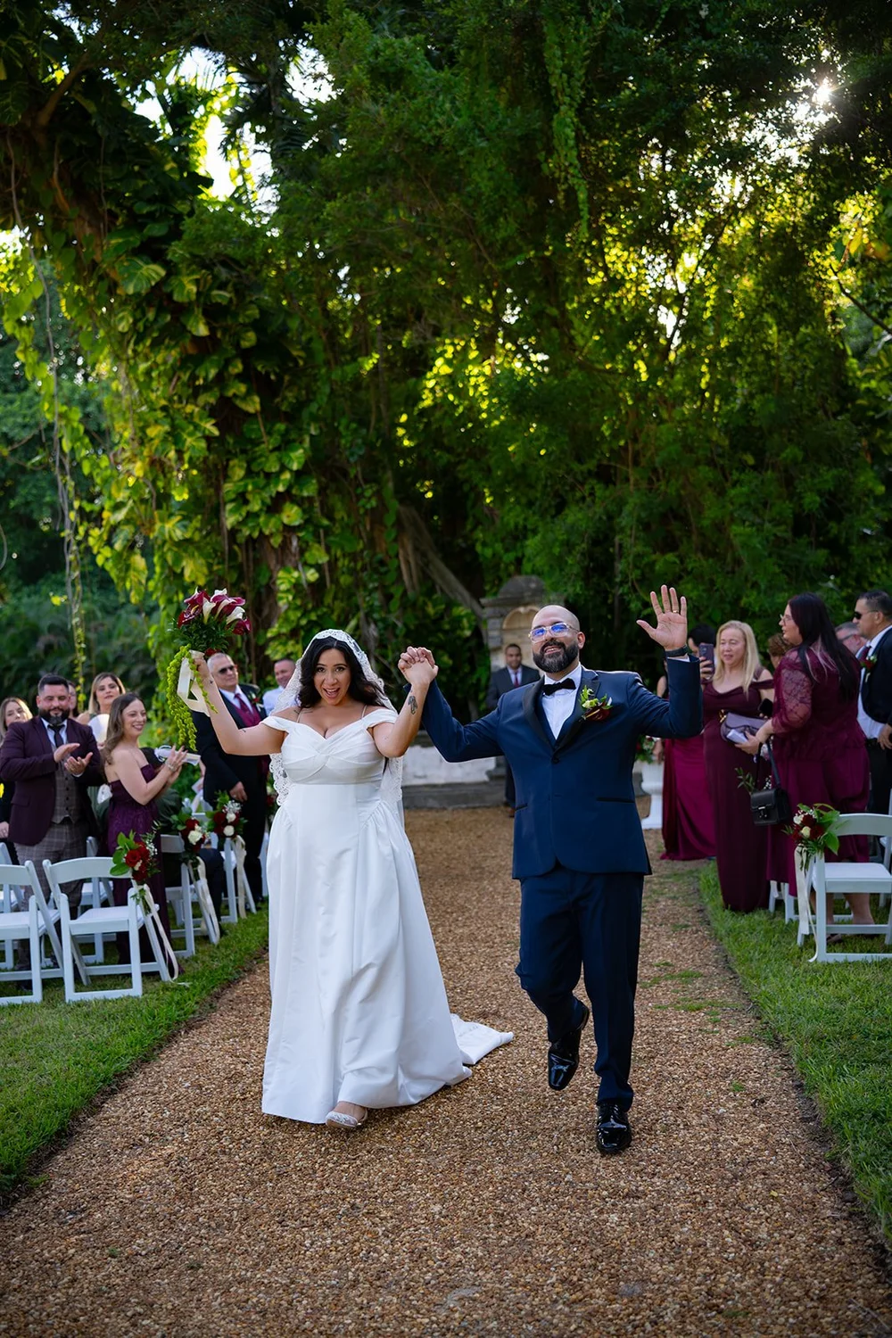 Maria and Christian walking back down the aisle as guests cheer on both sides
