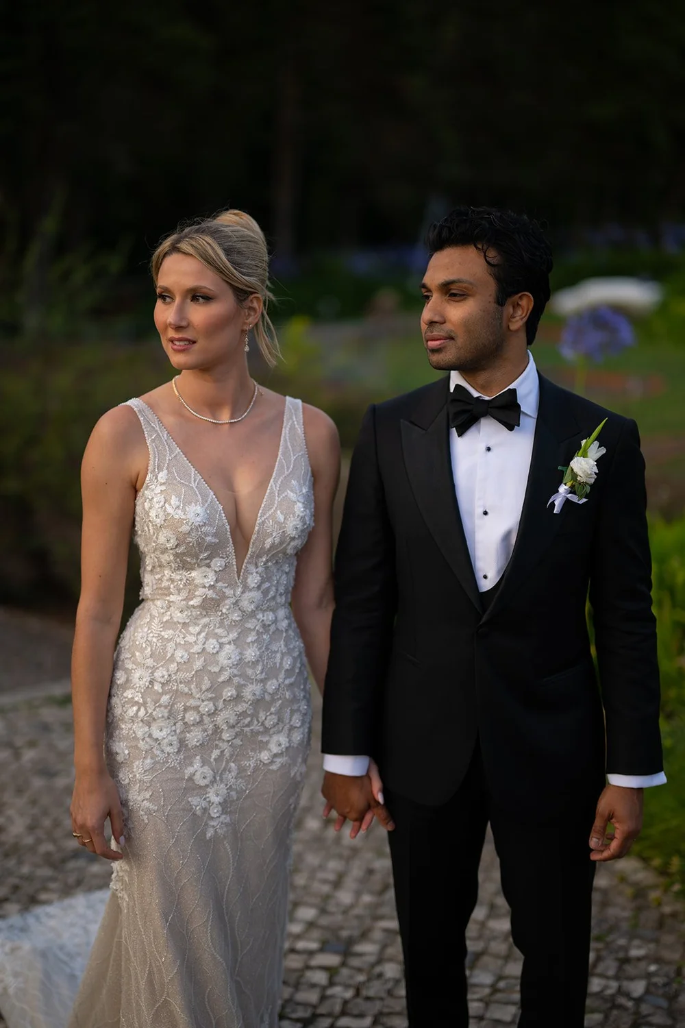 Ellen and Jacob standing side by side on a garden path