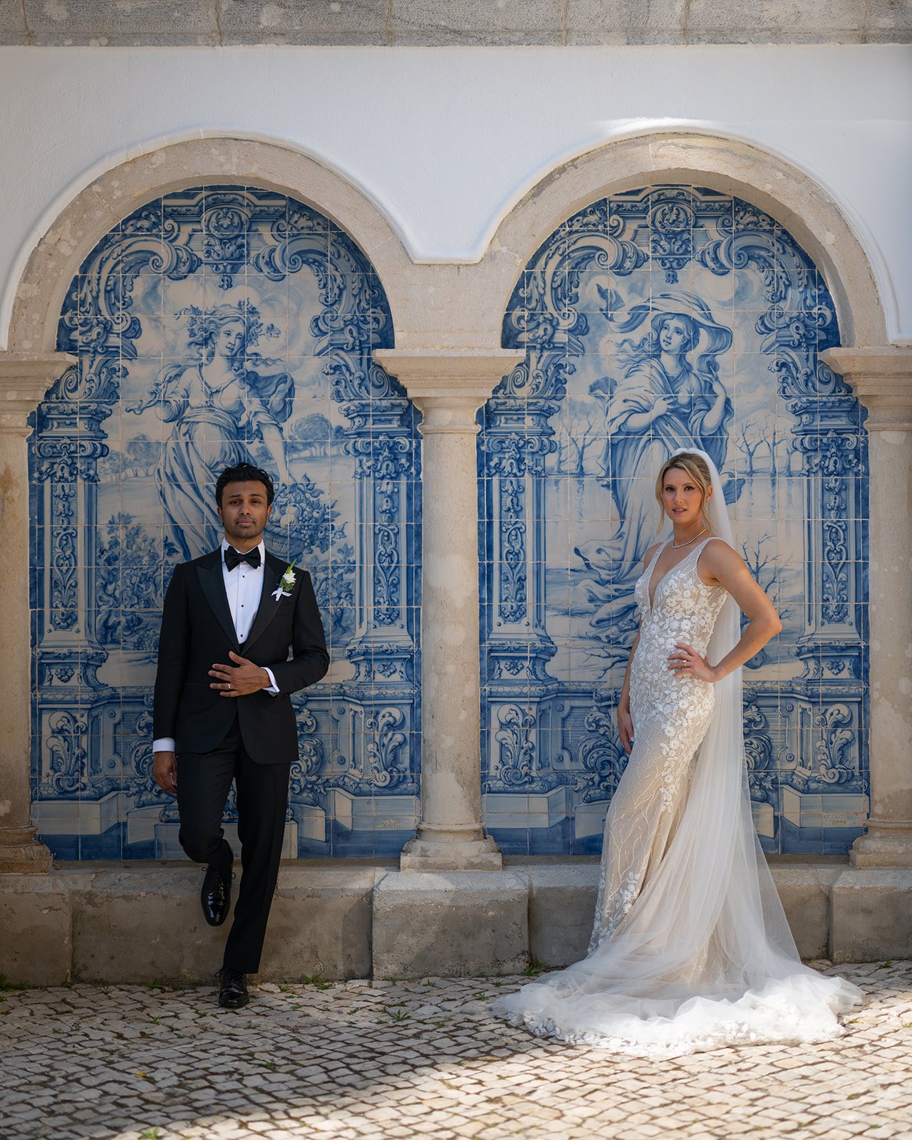 Ellen and Jacob standing together in front of blue azulejo tile panels at Penha Longa in Sintra, Portugal